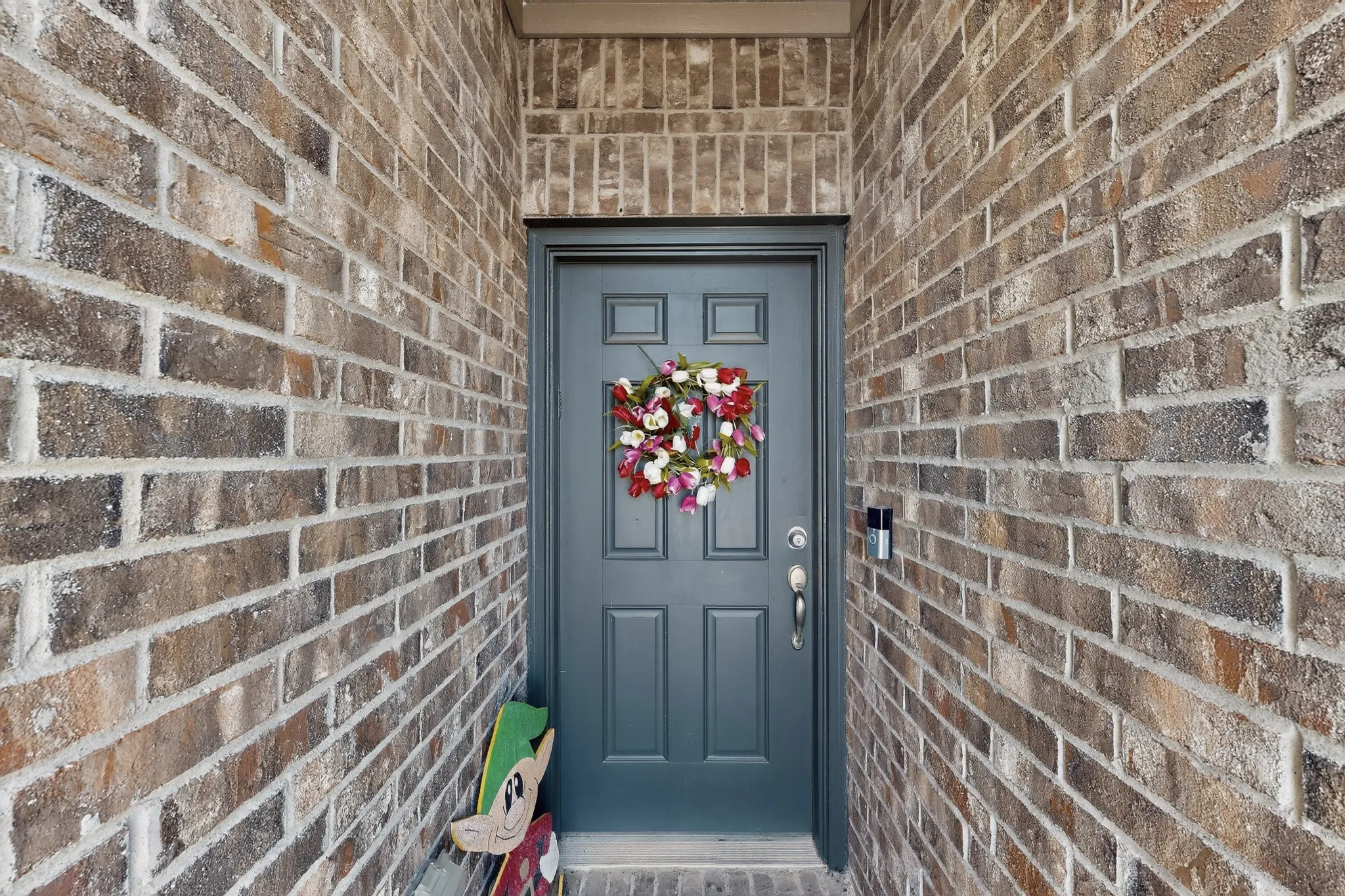 Entrance to property featuring brick siding
