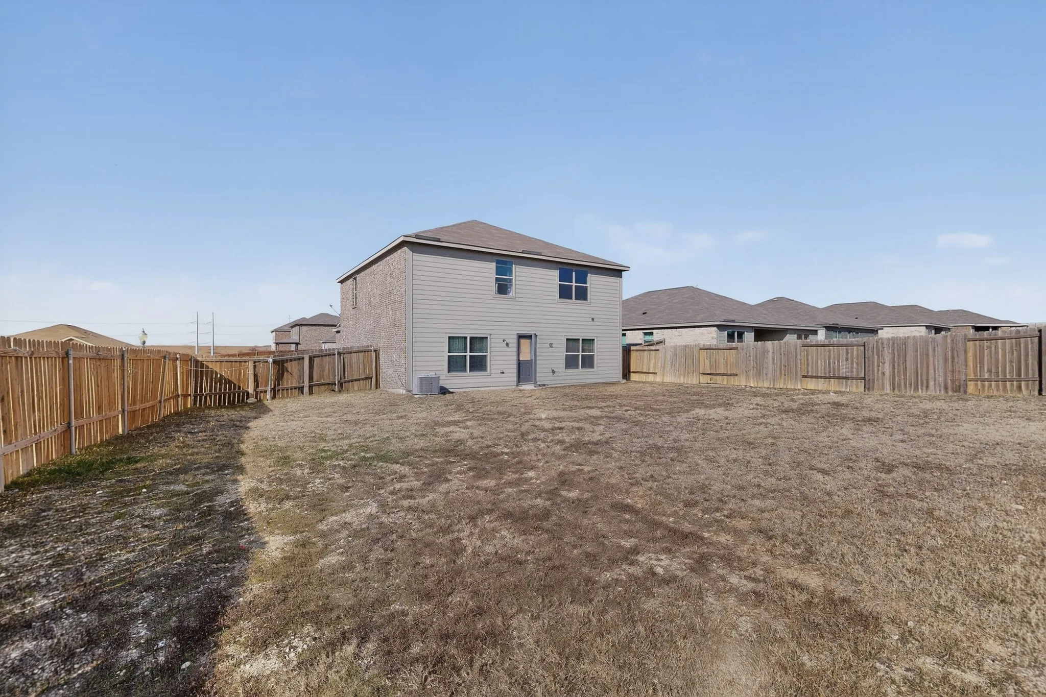 Back of property featuring a fenced backyard