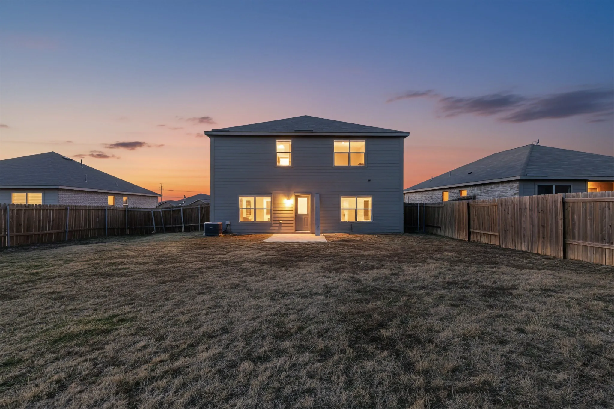 Back of house with a patio area and a fenced backyard