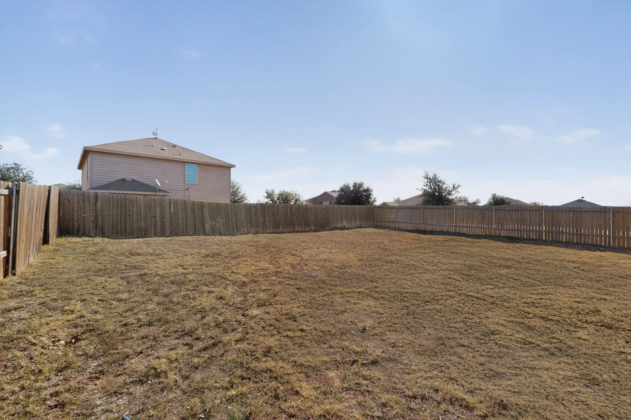 View of fenced backyard