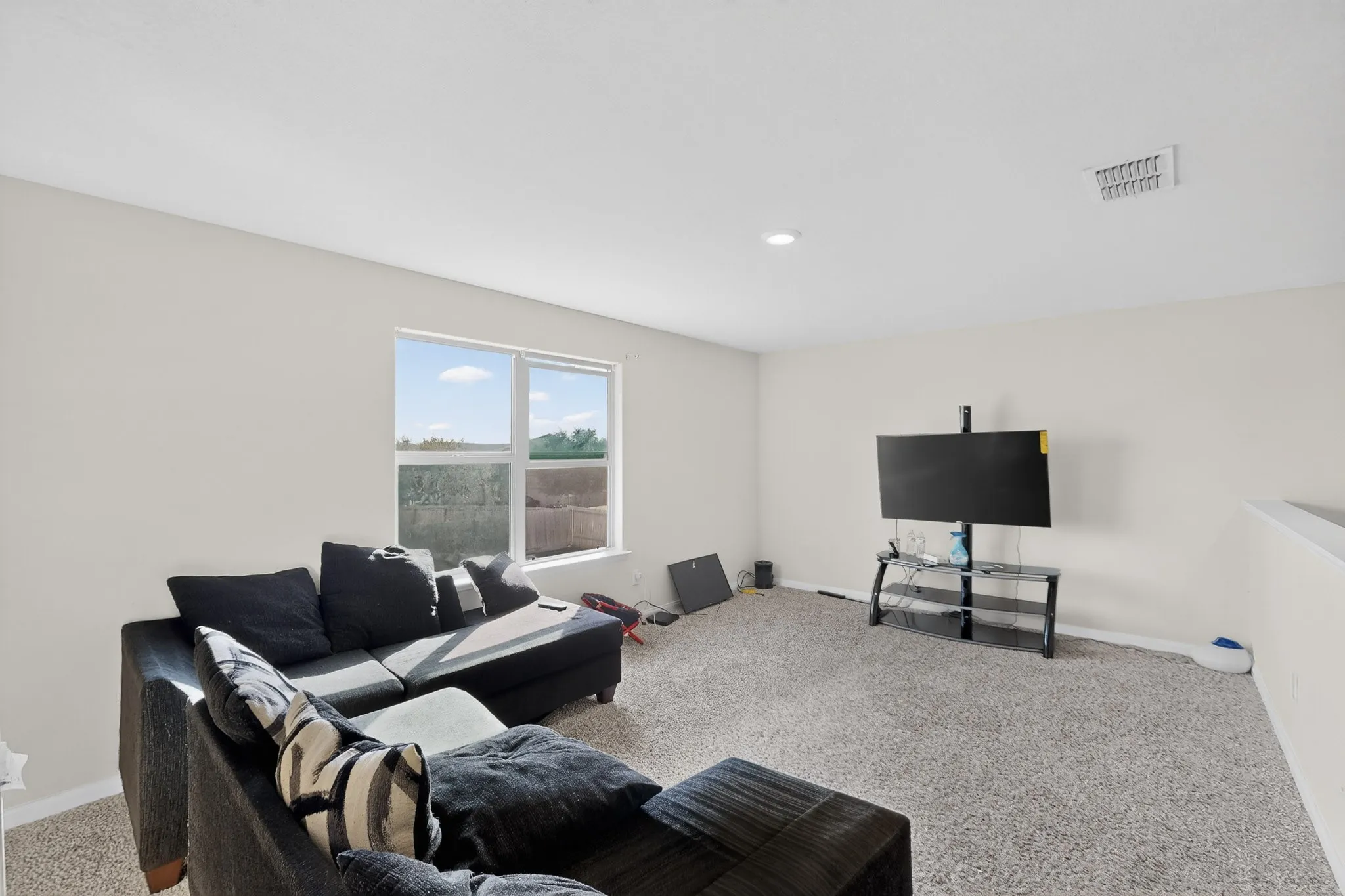 Carpeted living area with baseboards