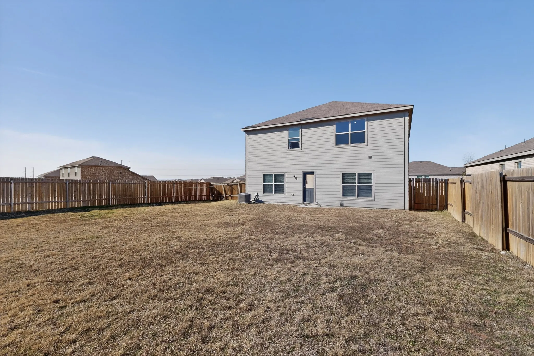 Back of property featuring a fenced backyard