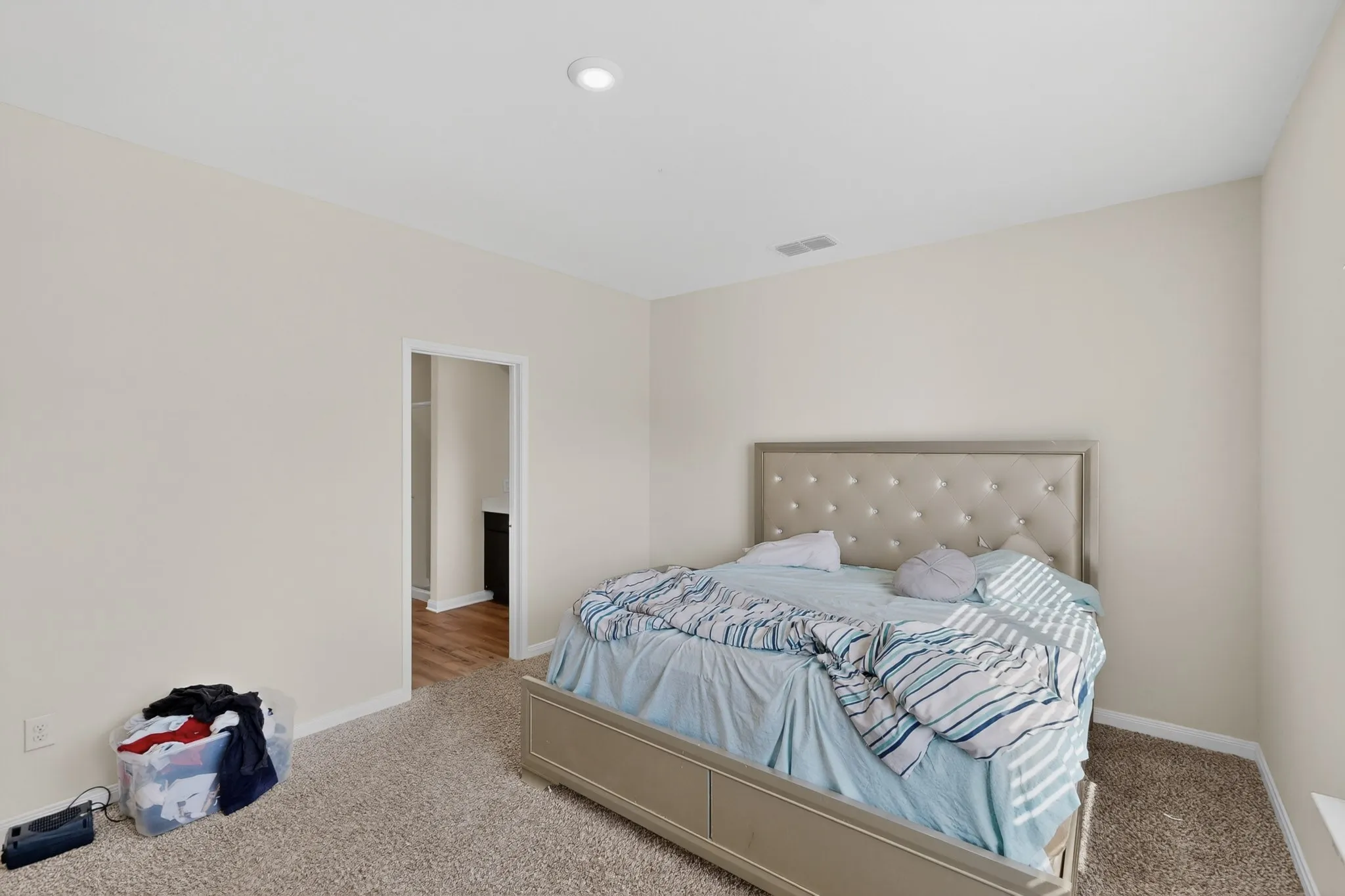 Carpeted bedroom with baseboards