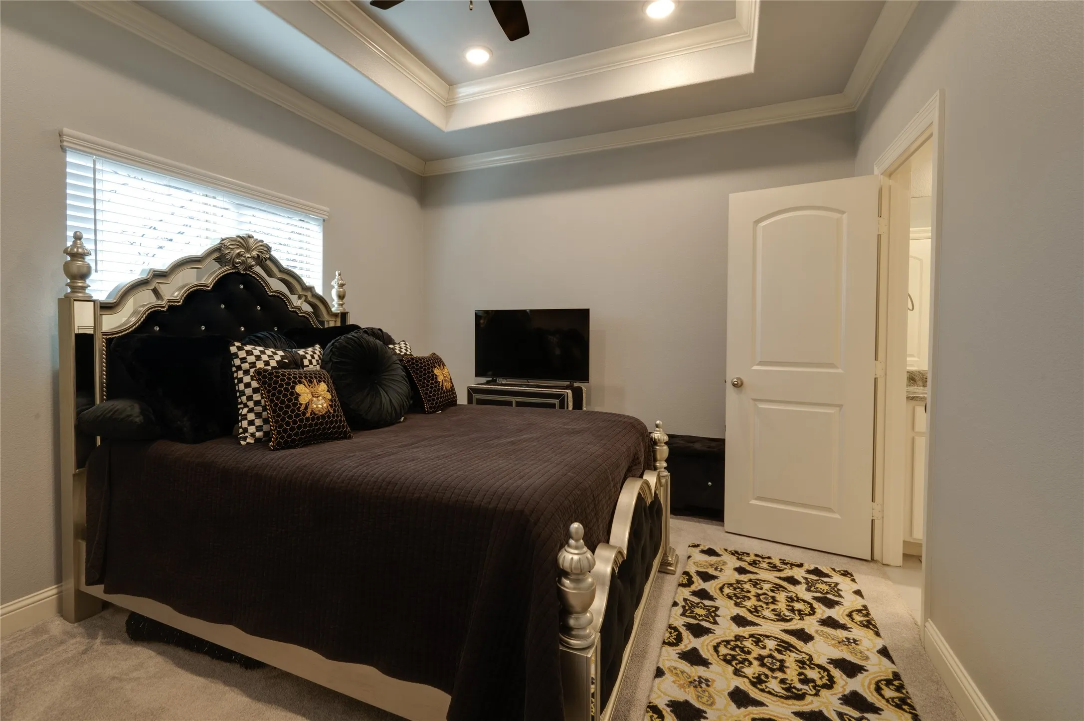 2nd bedroom with tray ceilings and walk in closet.