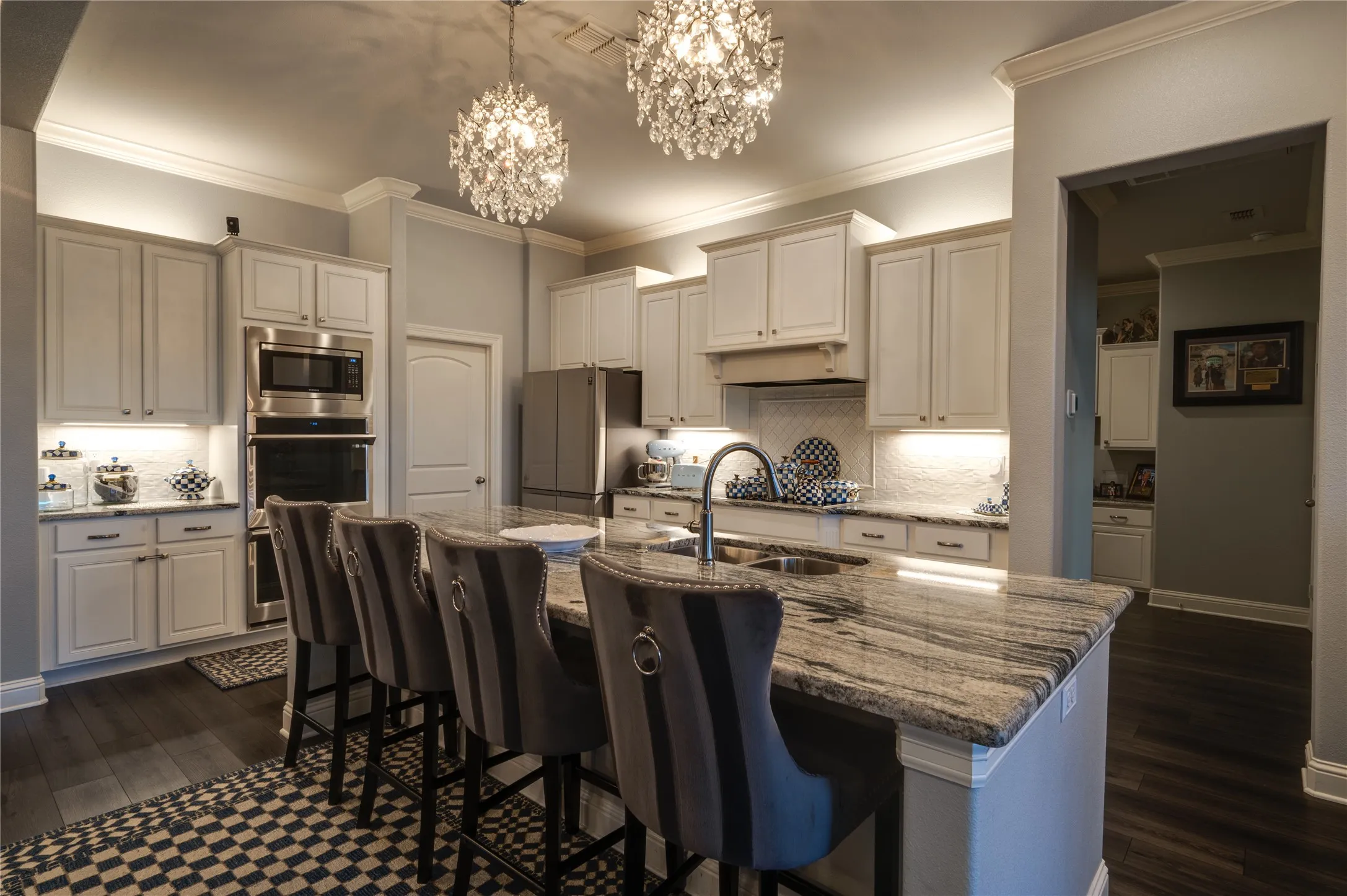 Chefs kitchen featuring custom cabinetry with lighting above and under cabinets, creating a warm, elevated ambiance and excellent task lighting.
