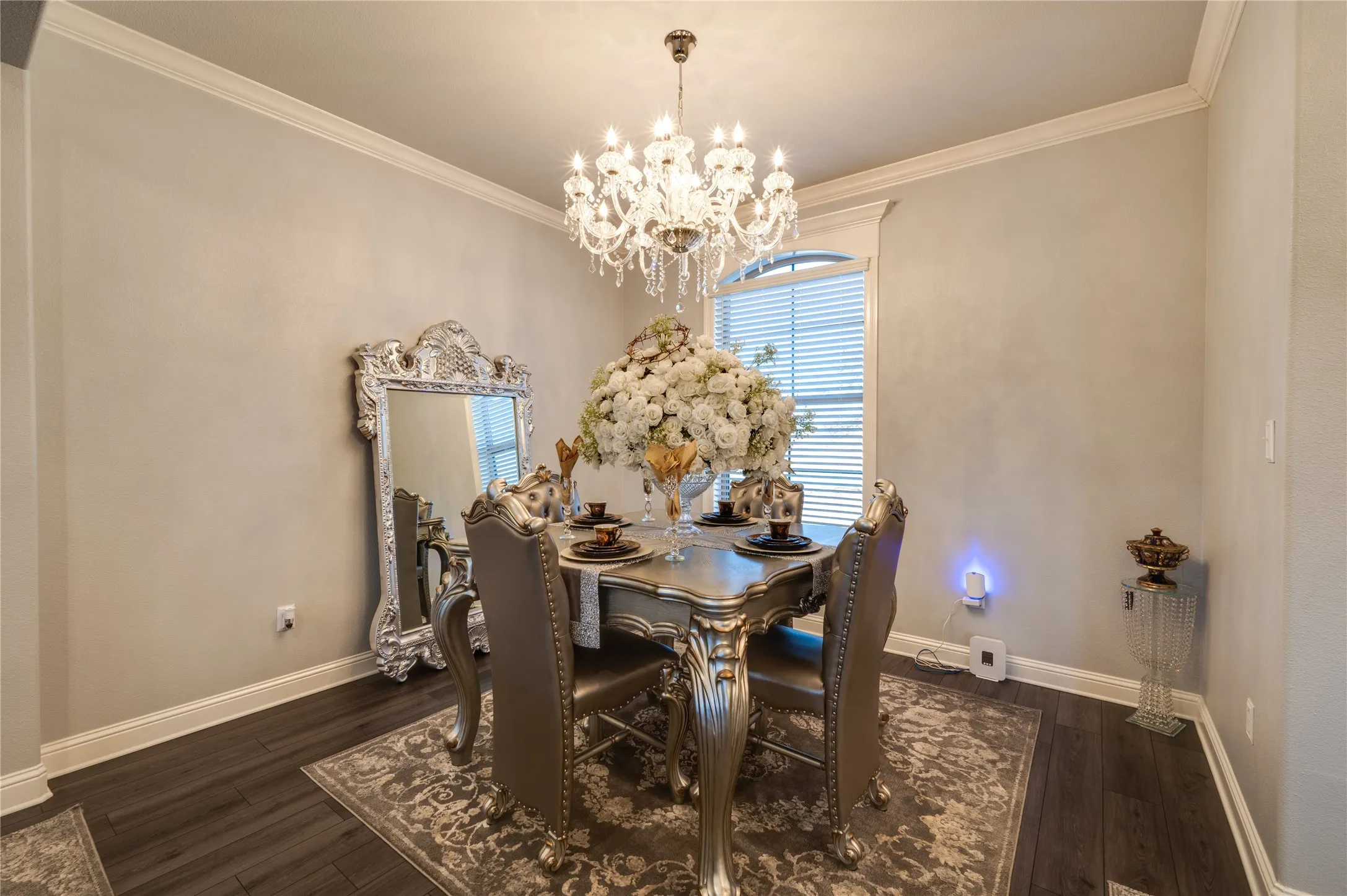Elegant formal, dining area featuring white crown molding that adds architectural detail and refined charm.