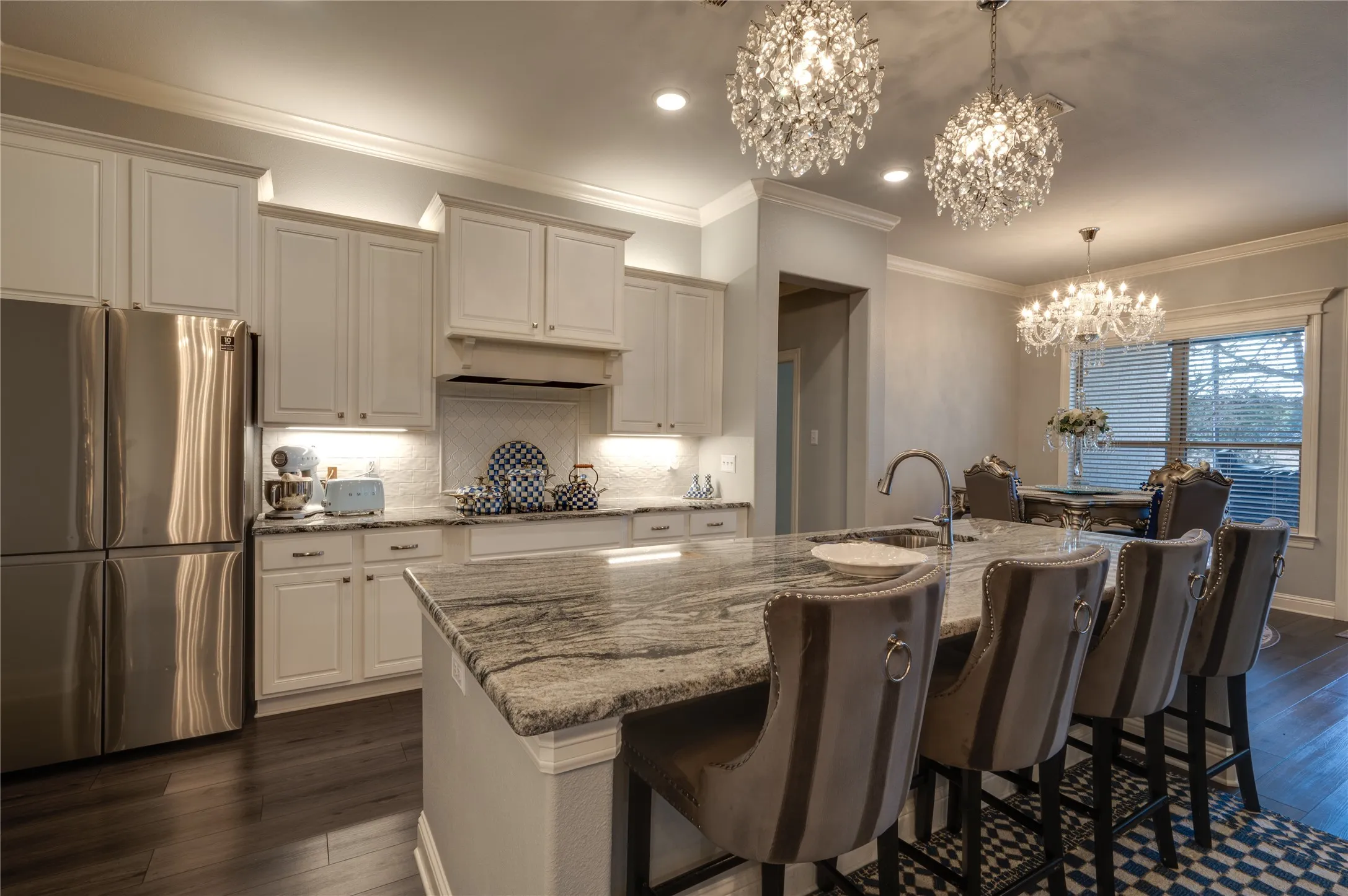 Stunning Chefs kitchen with custom cabinetry highlighted by elegant above and under cabinet lighting, blending functionality with upscale design.