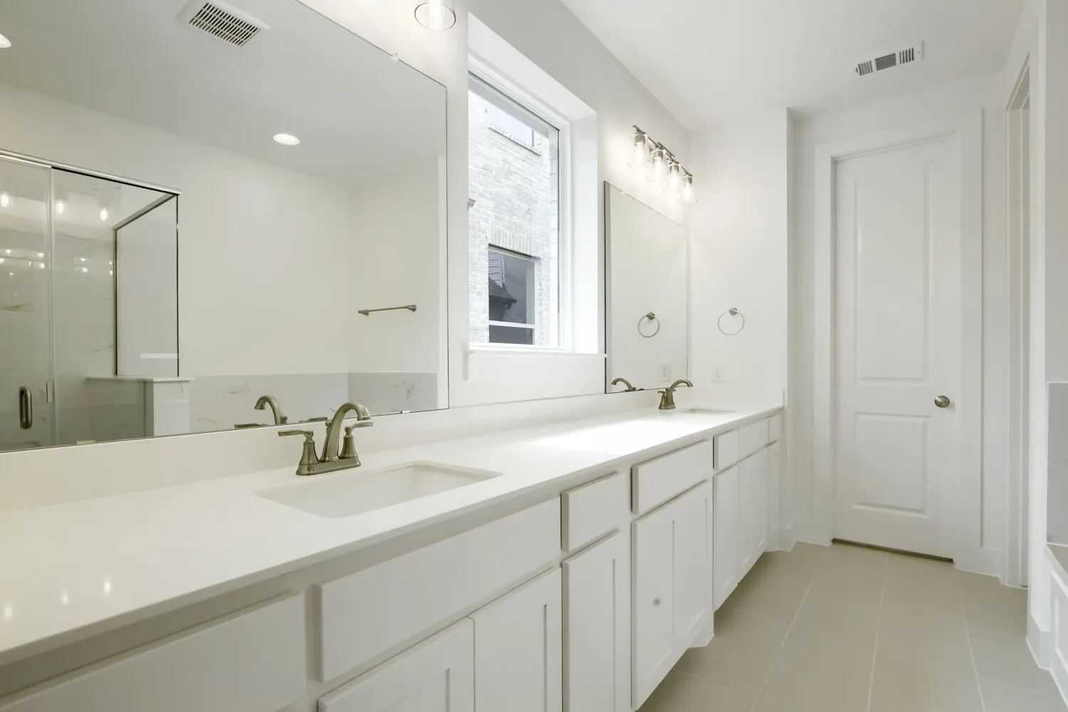 Double vanity with white cabinetry and integrated sinks