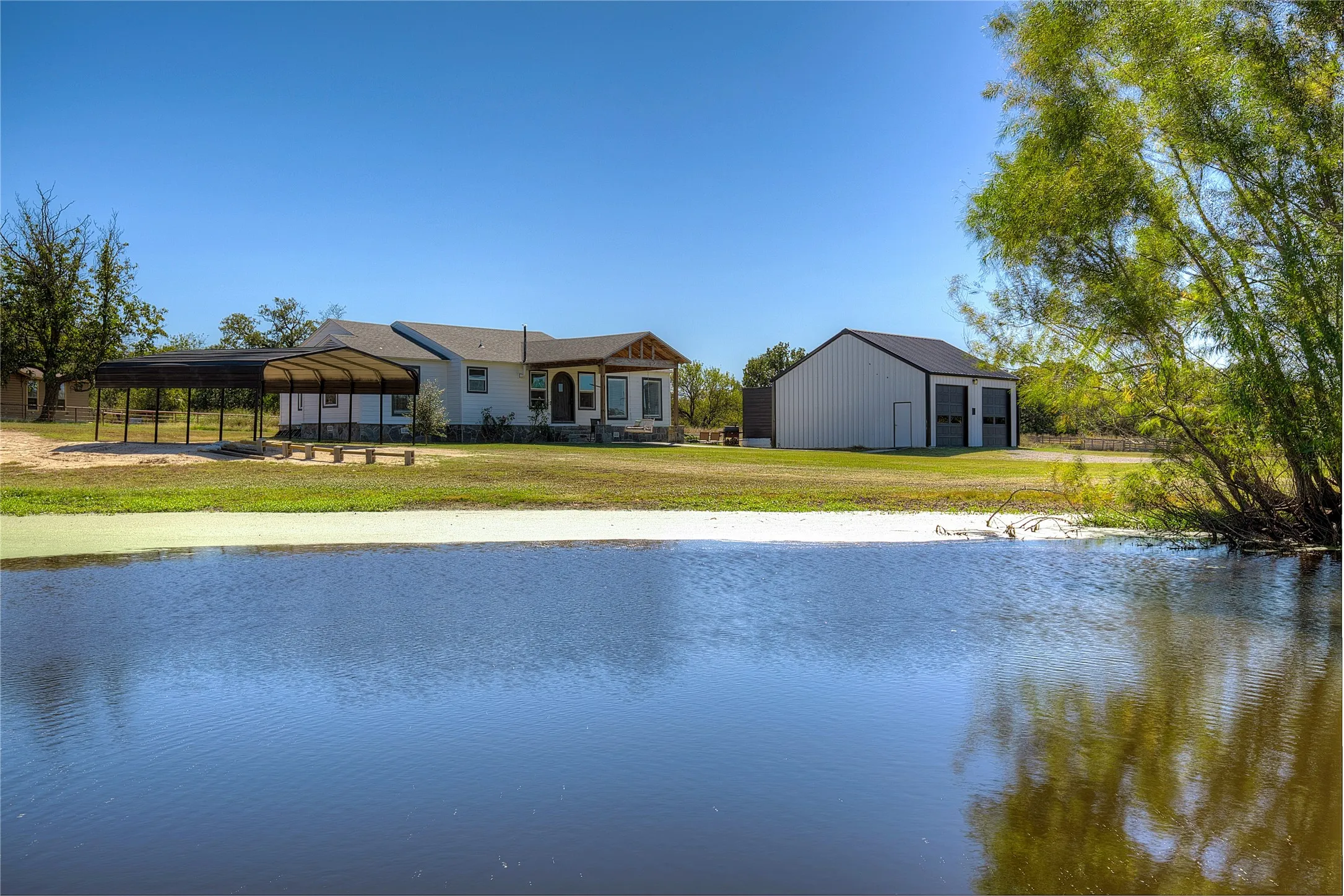 Pond with house in background.