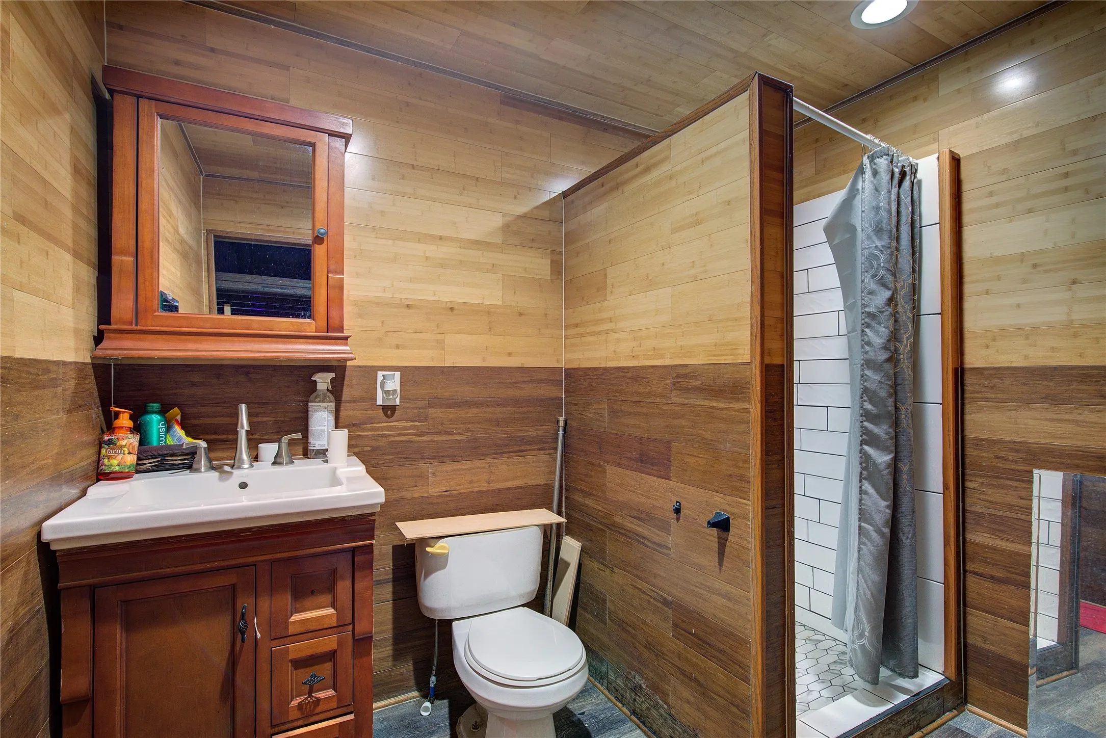 Bathroom inside garage includes shower.