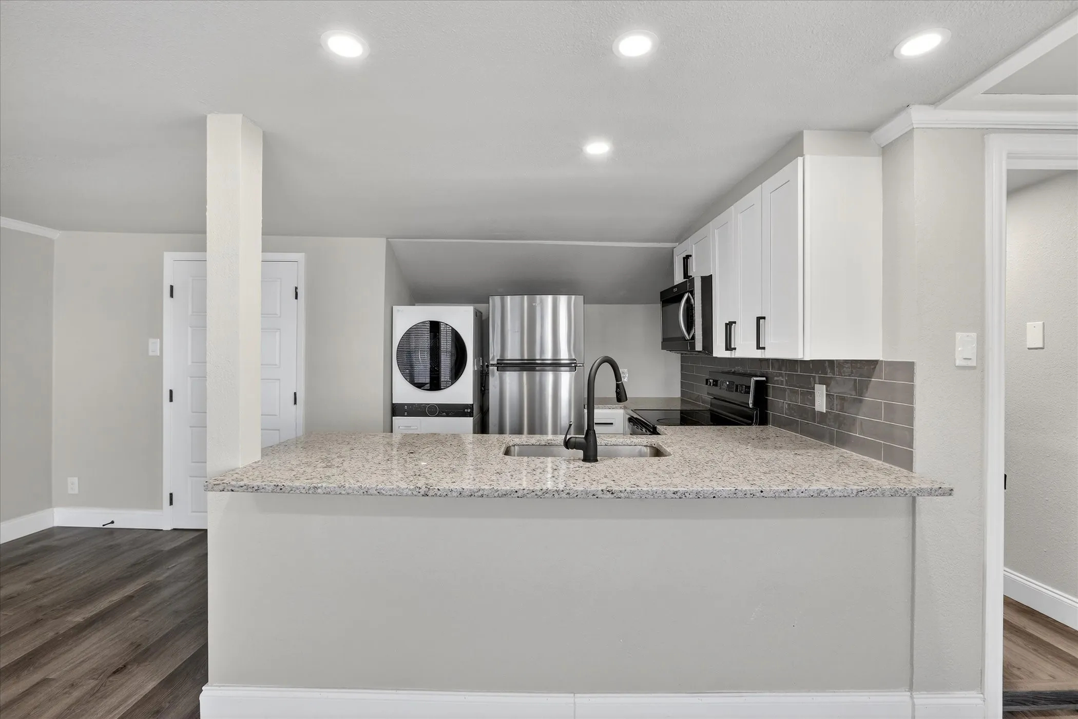 Nice breakfast bar with lovely granite countertops.
