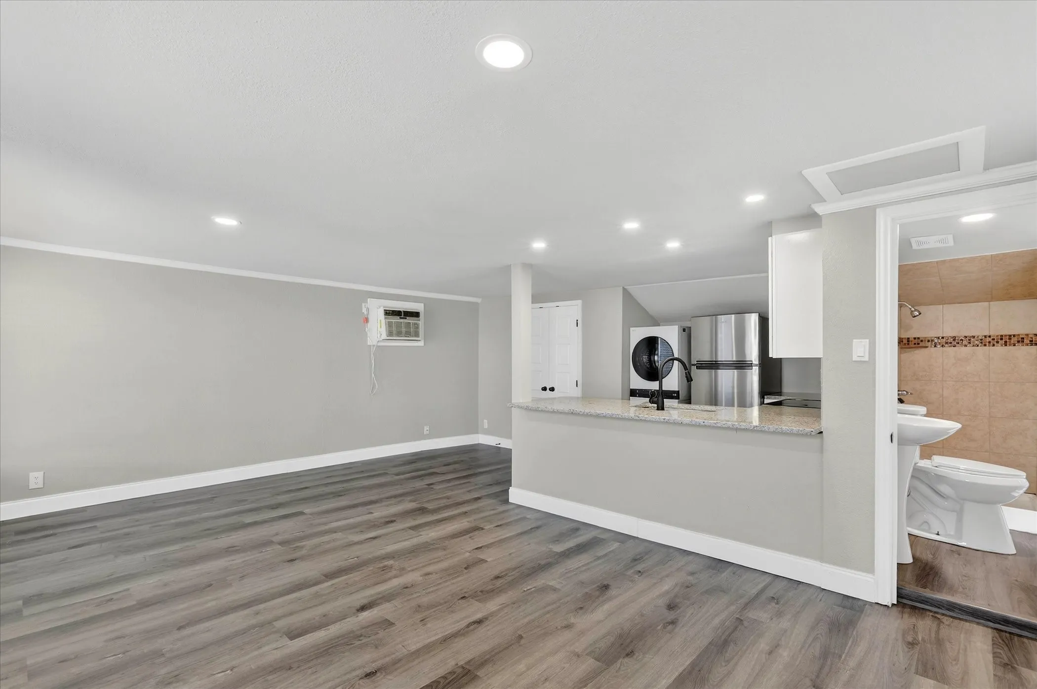 Inside the guesthouse with spacious living area, beautiful kitchen, granite countertops, stainless appliances and washer and dryer!