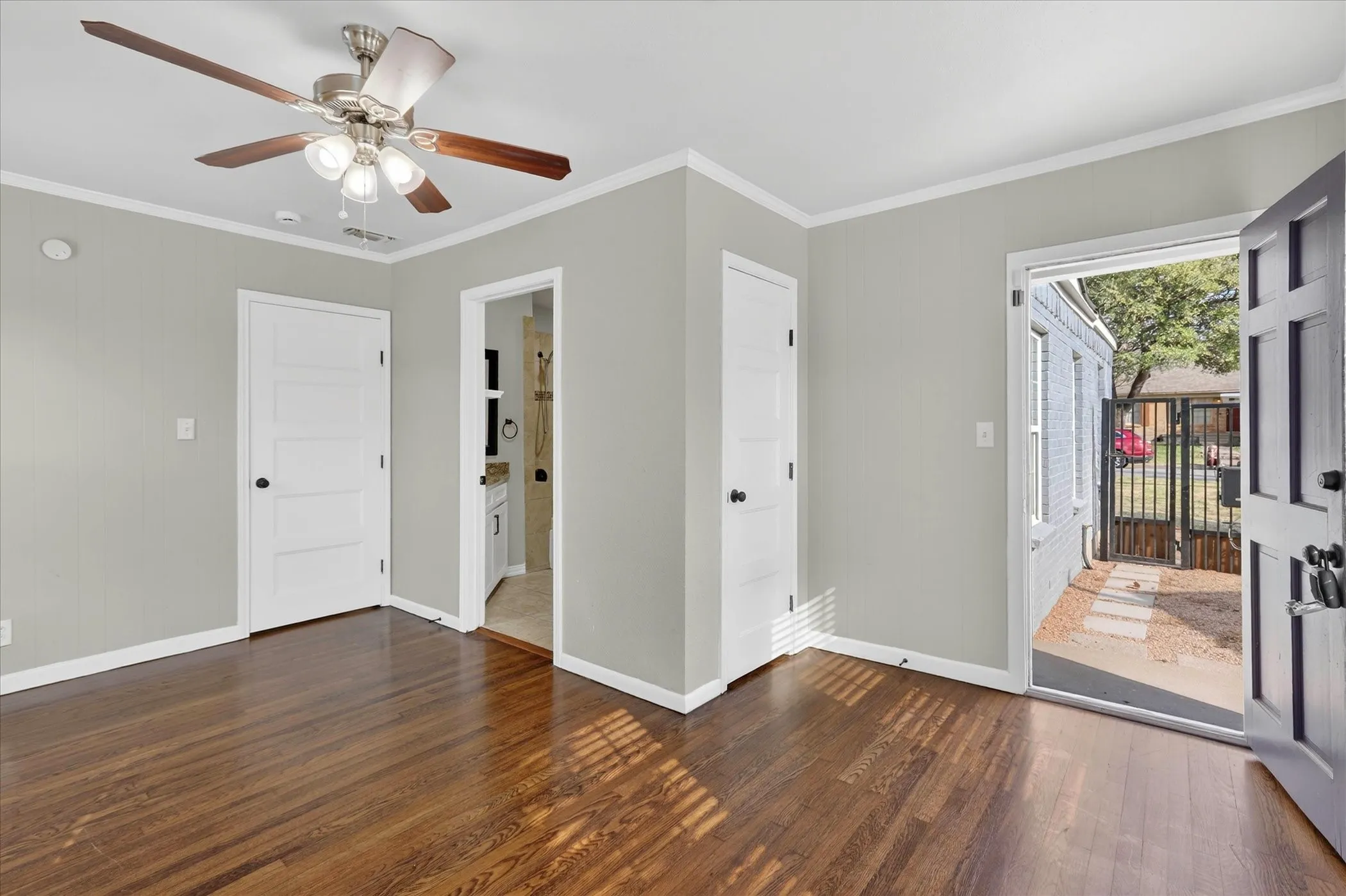 Second bedroom with ensuite bathroom, closet and private door leading to backyard.