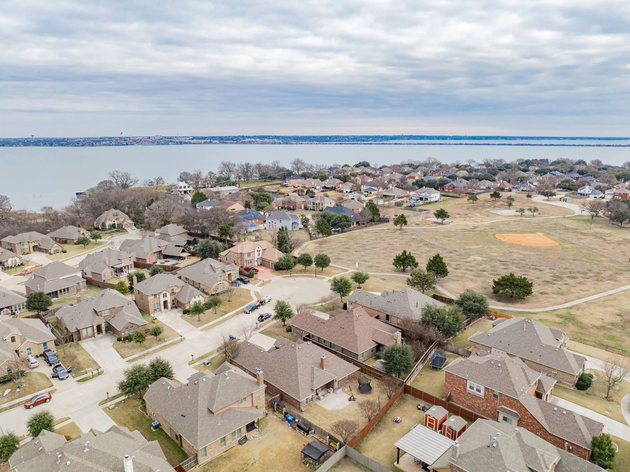 Aerial view of residential area featuring a large body of water