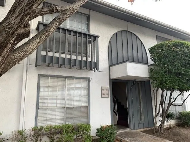 Entrance to property featuring stucco siding