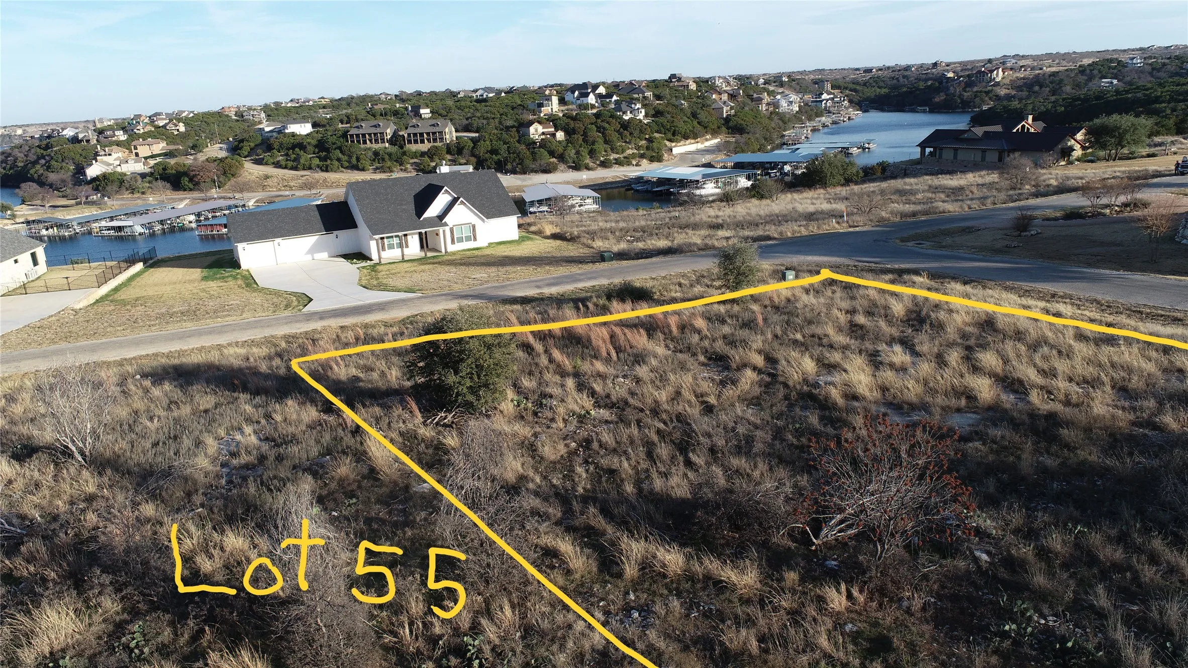 Drone shot captures the empty lots and already built houses surrounding this property.  Are you ready to build?