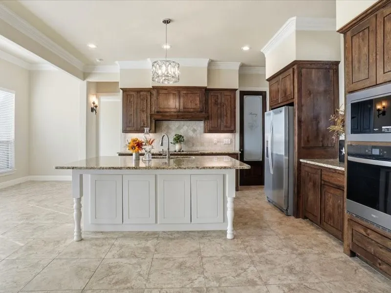 Note the quality cabinetry, large  Island  and Refrigerator stays