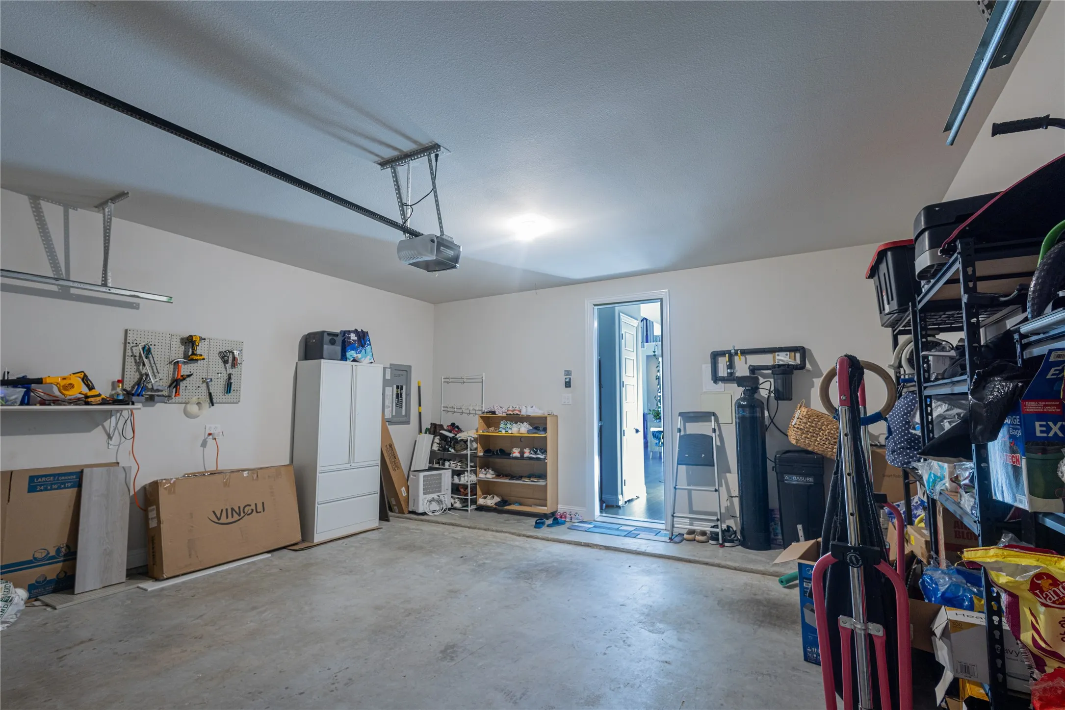 Garage with electric panel and a garage door opener