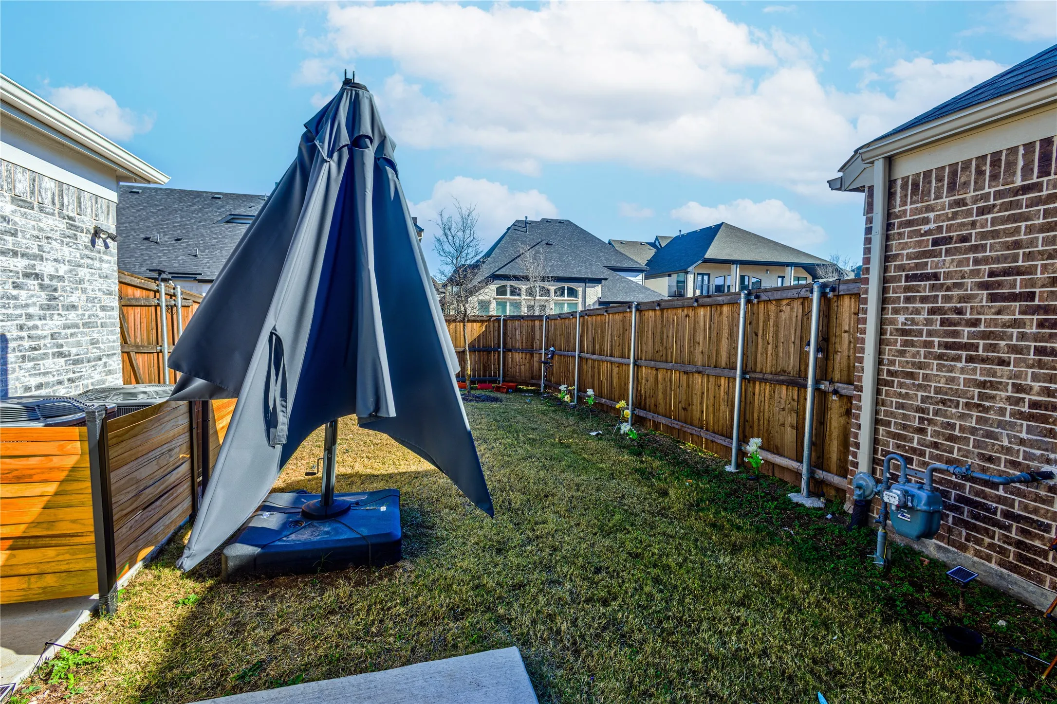 Fenced backyard featuring a residential view