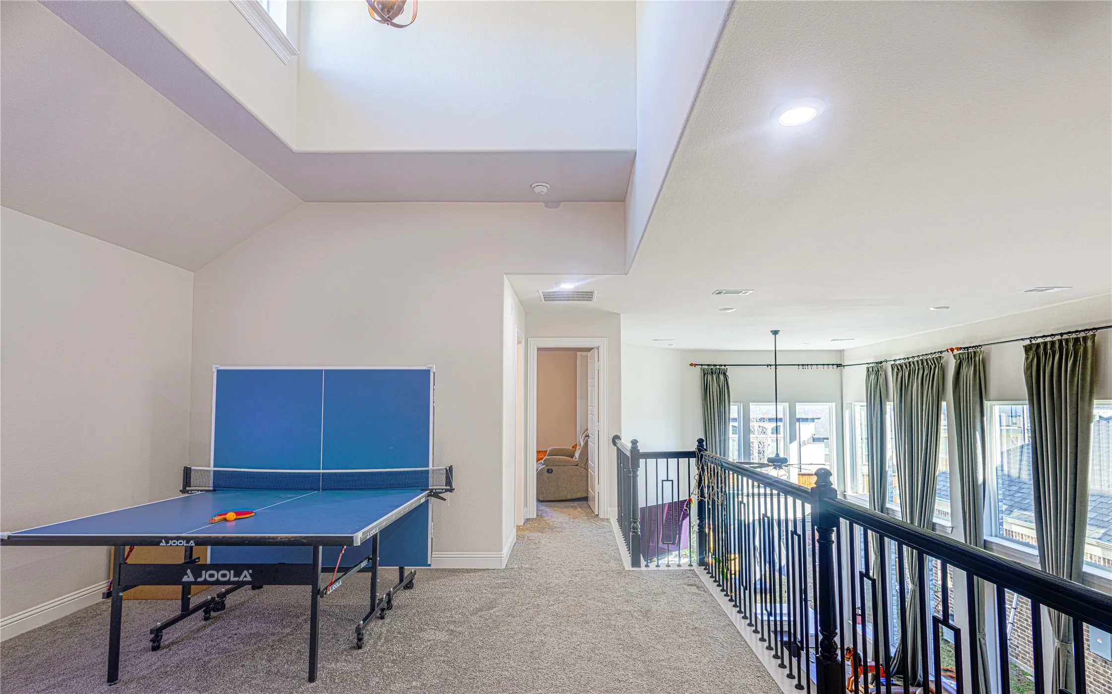 Playroom with plenty of natural light, carpet floors, and lofted ceiling