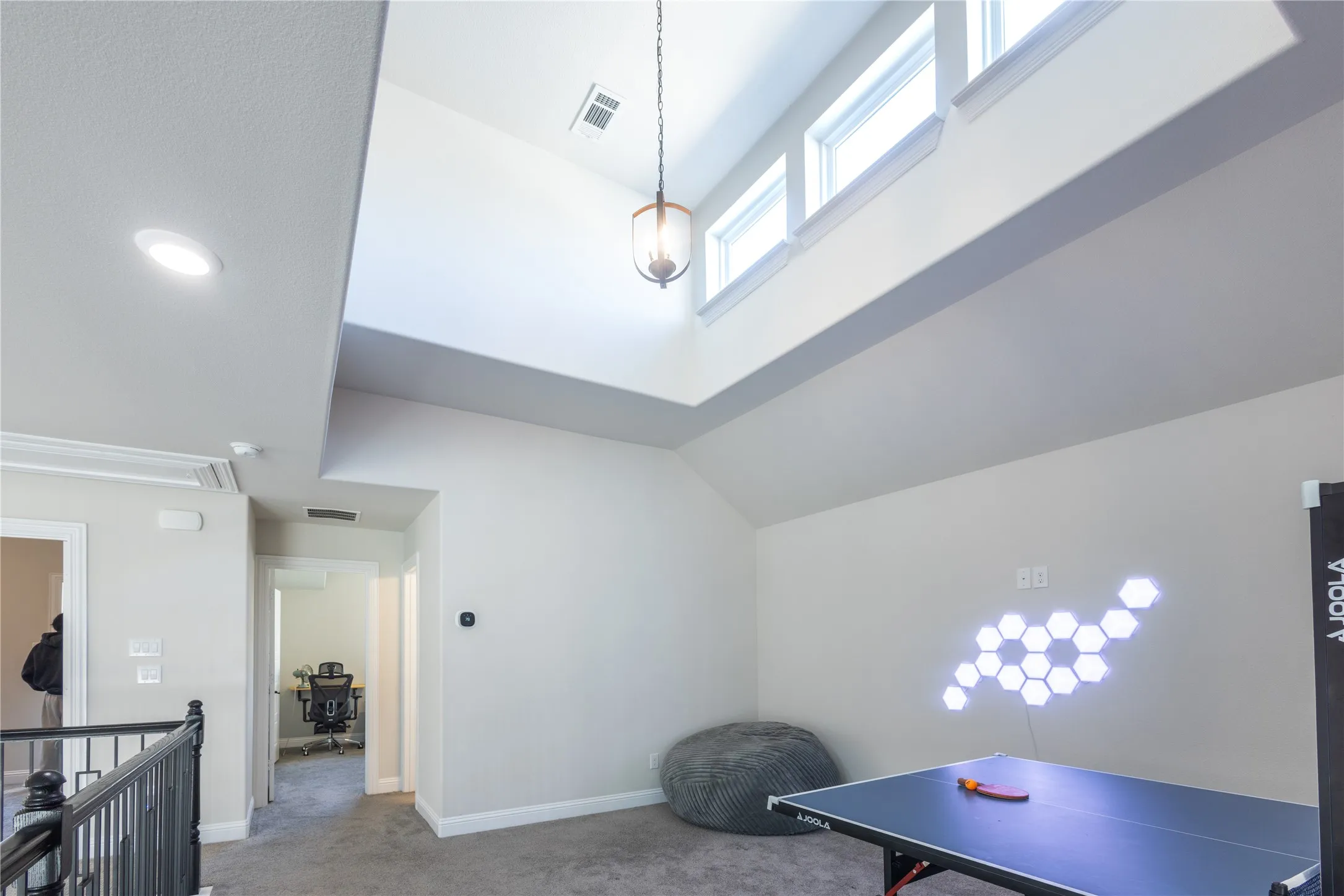 Playroom featuring carpet and lofted ceiling