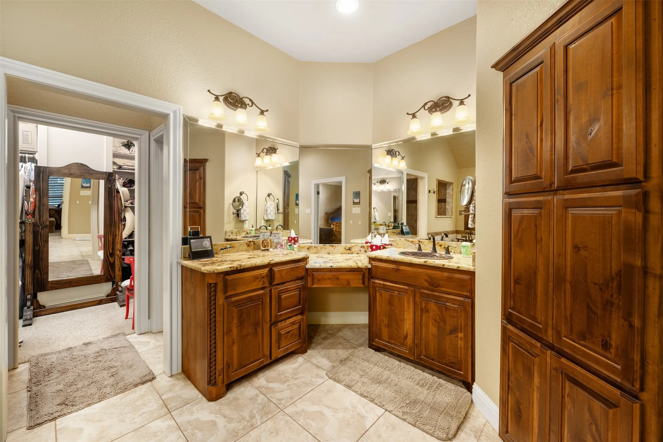 Her sink with view of custom closet