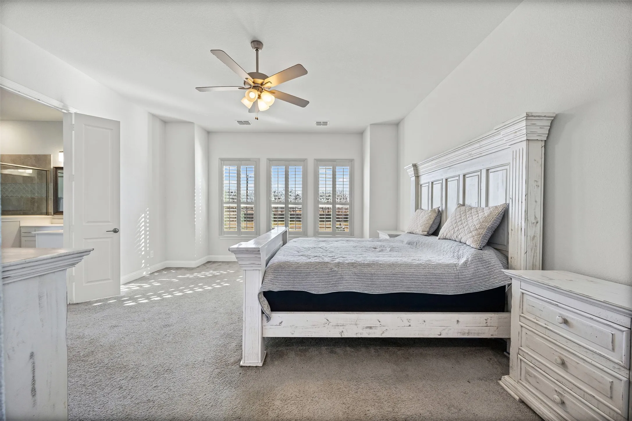 Primary bedroom with view of back yard