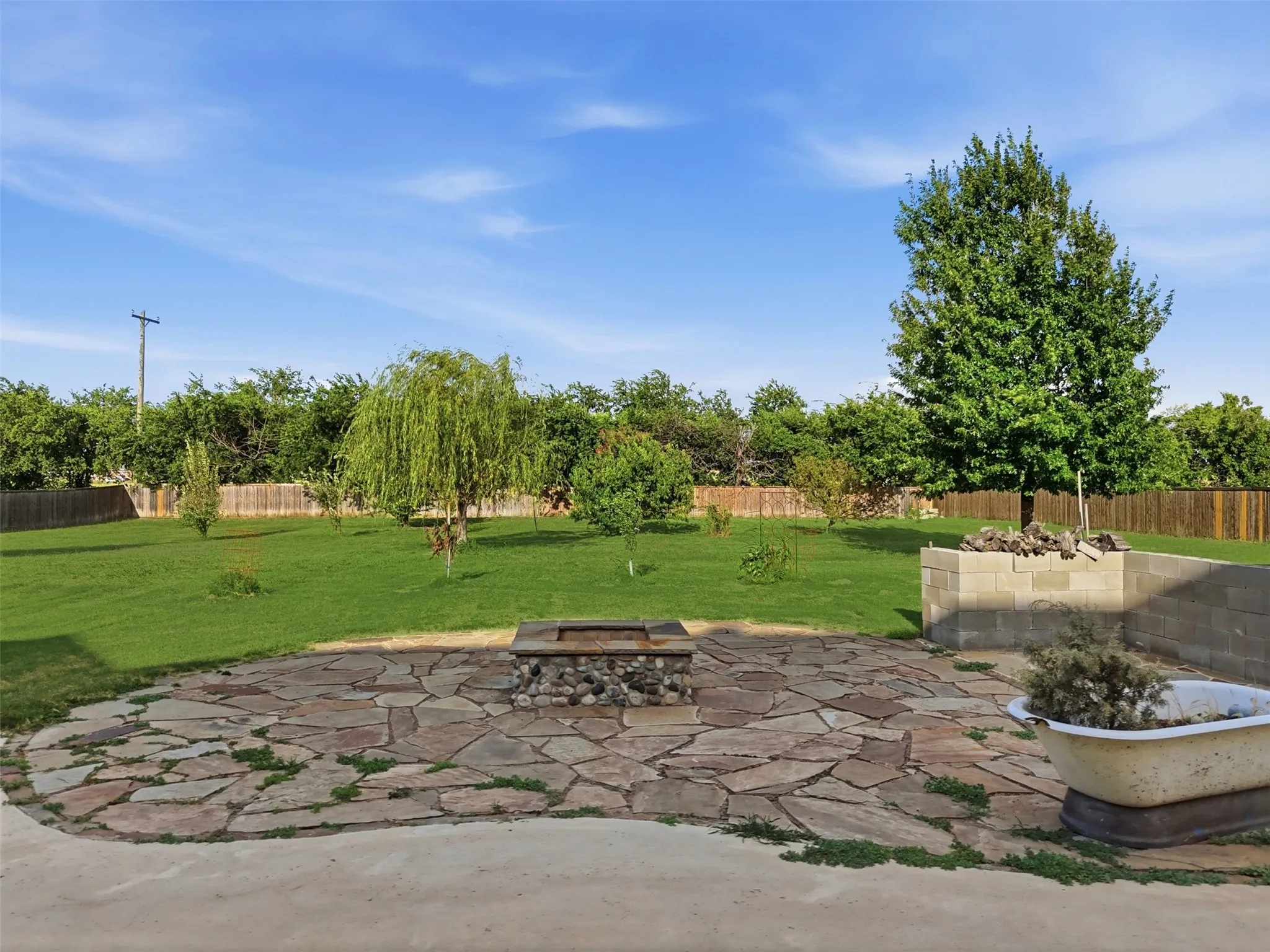 Firepit and grilling area on stone patio