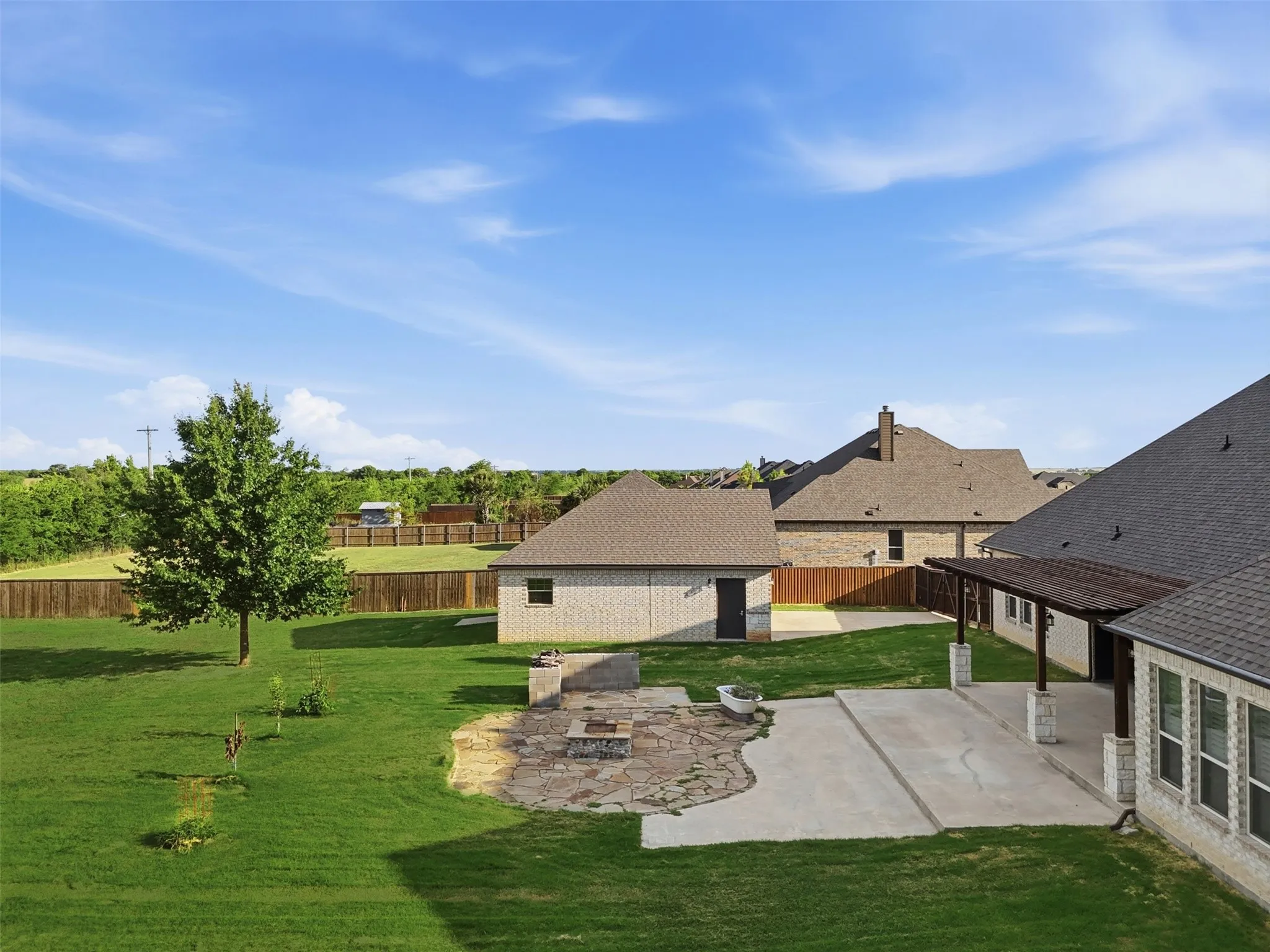 Backyard patio, firepit, and shop