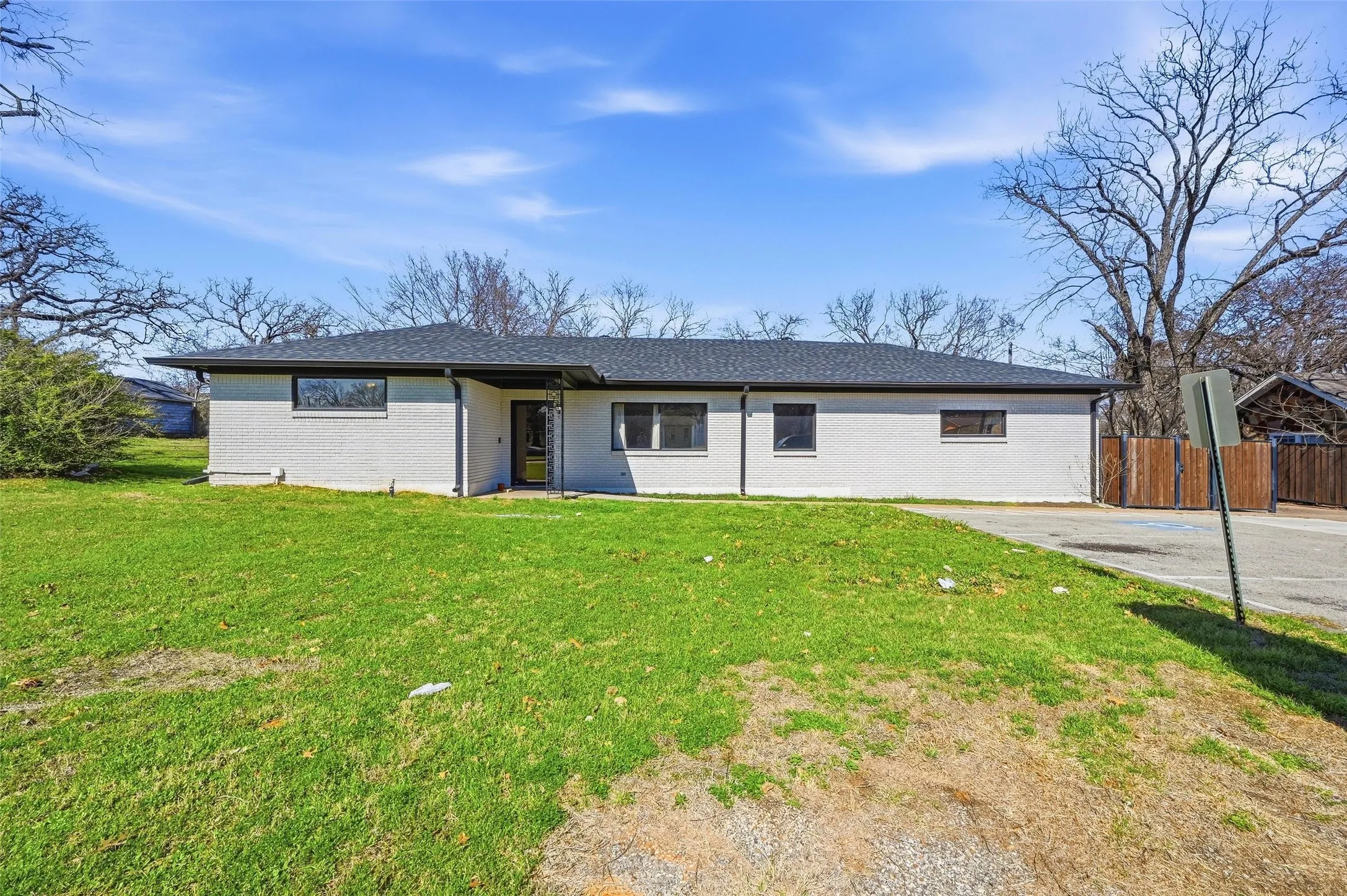 Single story home with brick siding and roof with shingles