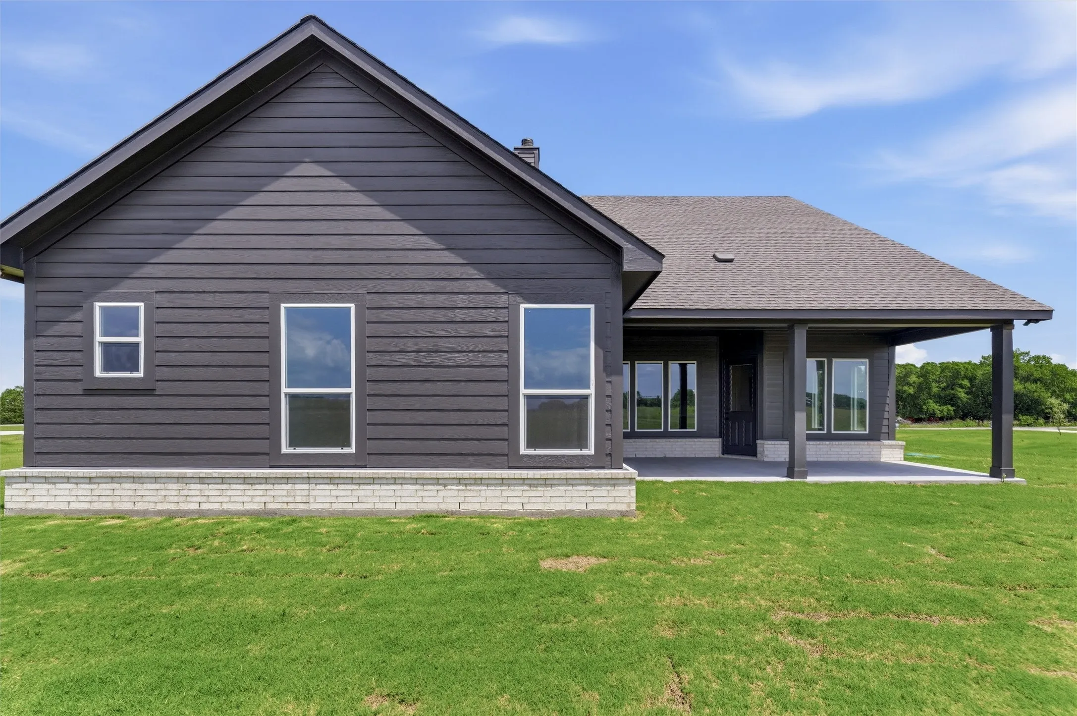 Dark siding exterior with white window trim