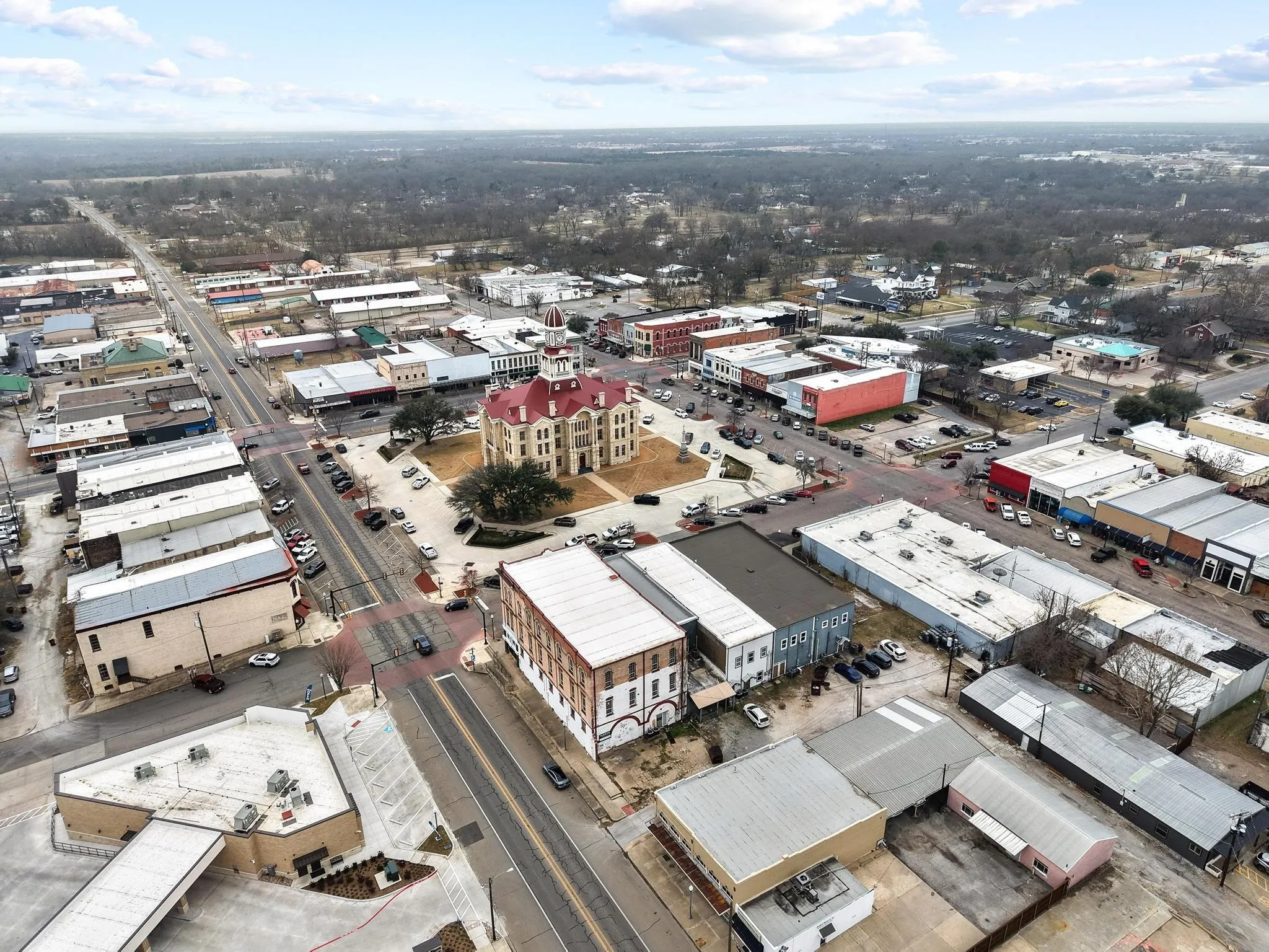 building has the black roof and is located on the north side of the Fannin County Courthouse