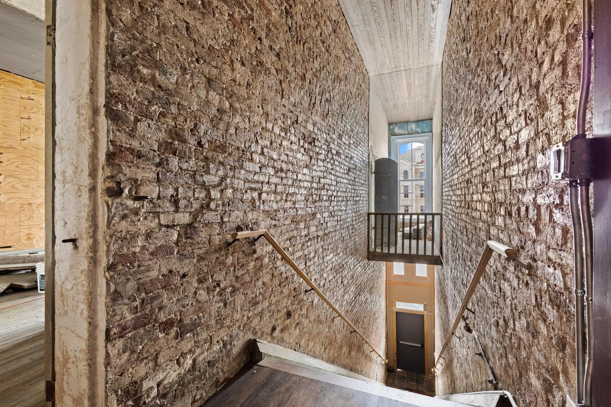 Front Staircase landing with a view of the mezzanine