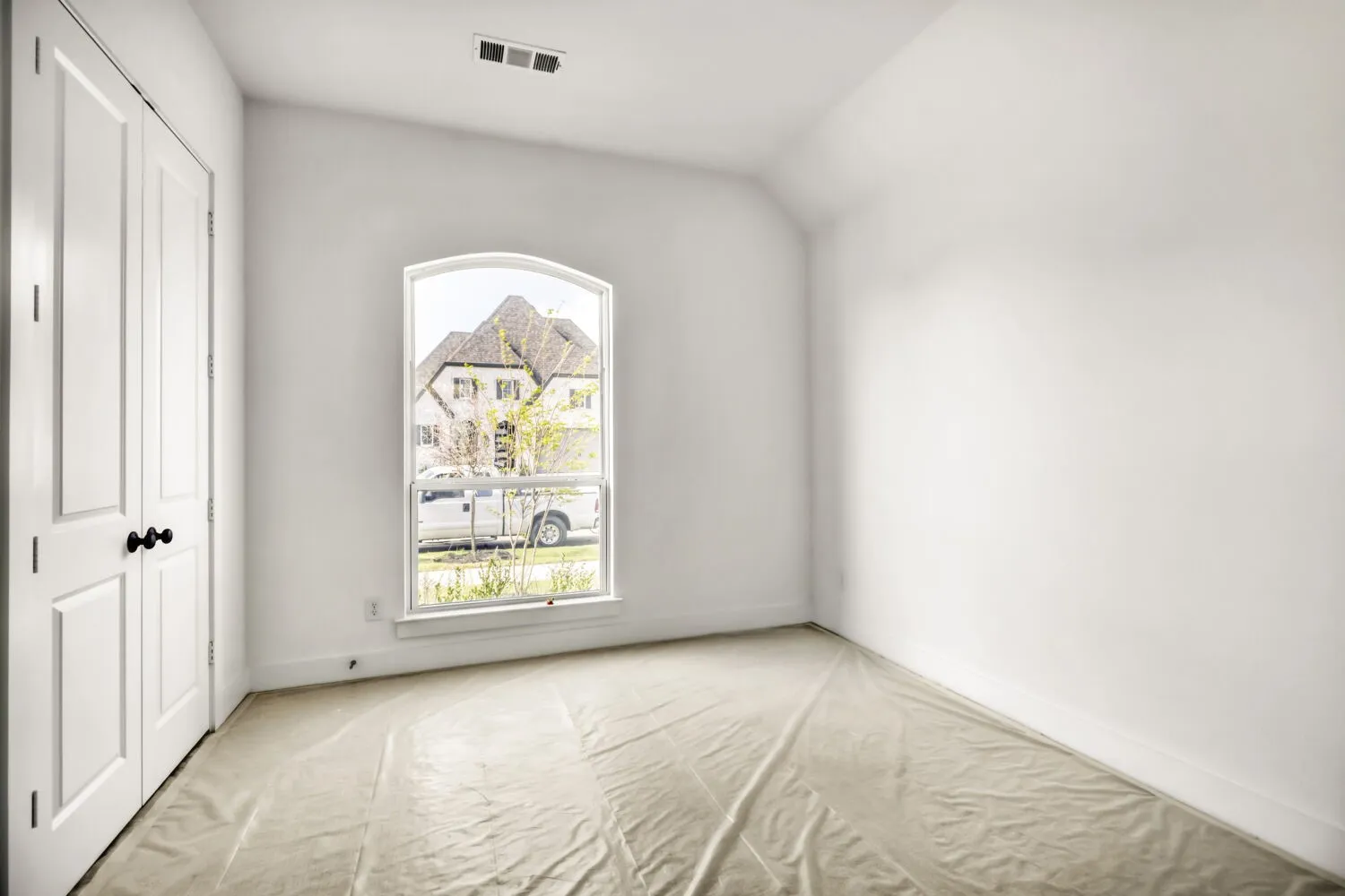 Unfurnished bedroom with a closet, lofted ceiling, and carpet