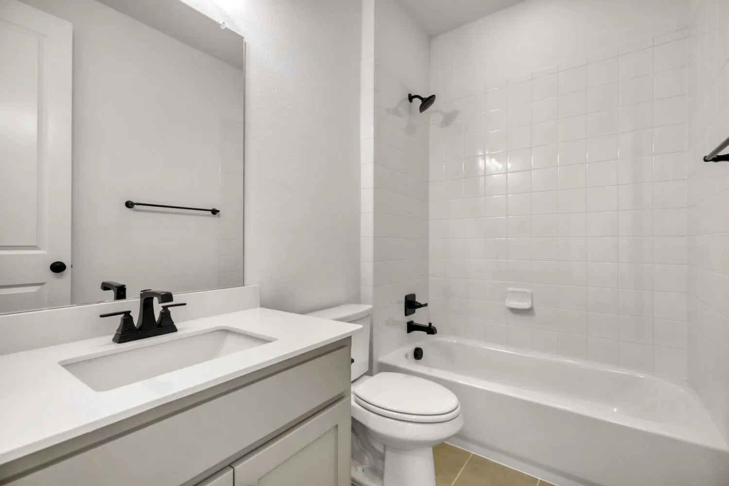 Full bathroom featuring vanity, bathtub / shower combination, and light tile patterned floors