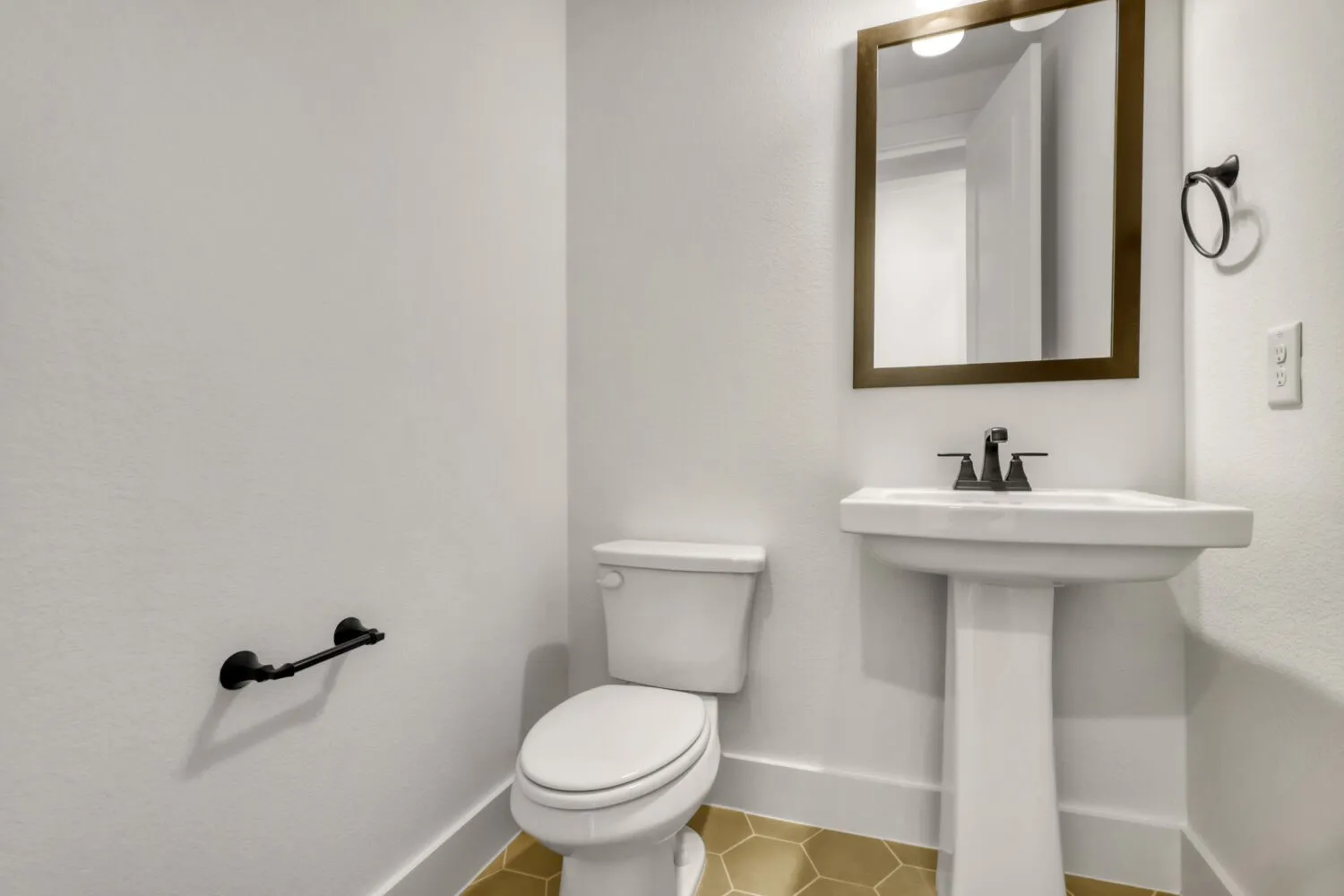 Half bathroom with toilet and light tile patterned floors