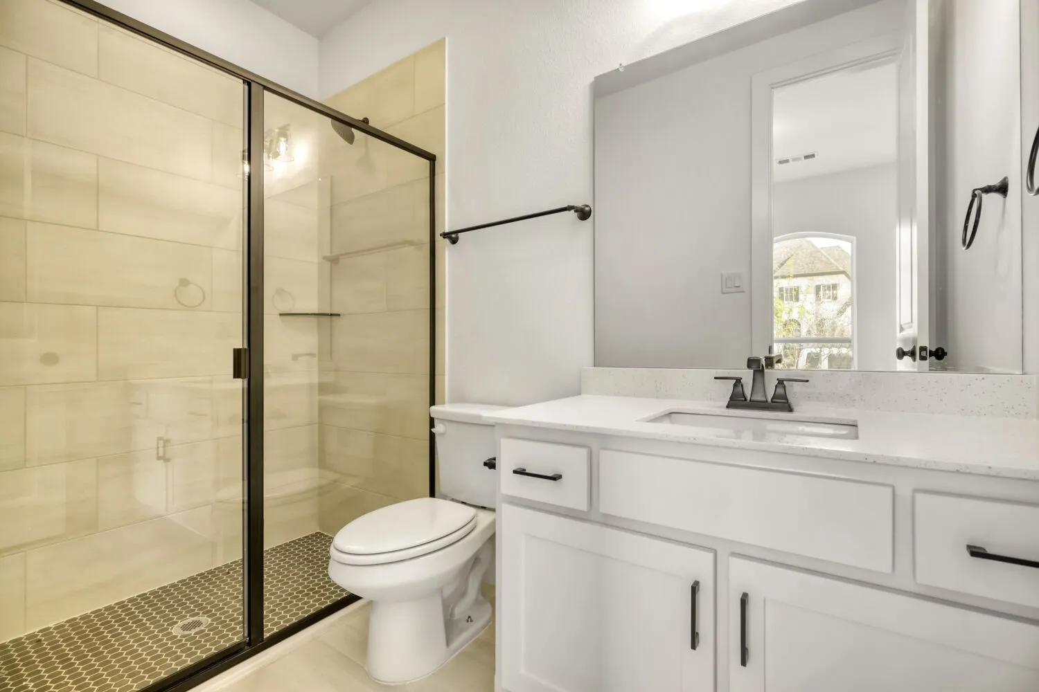 Full bath featuring a stall shower and vanity