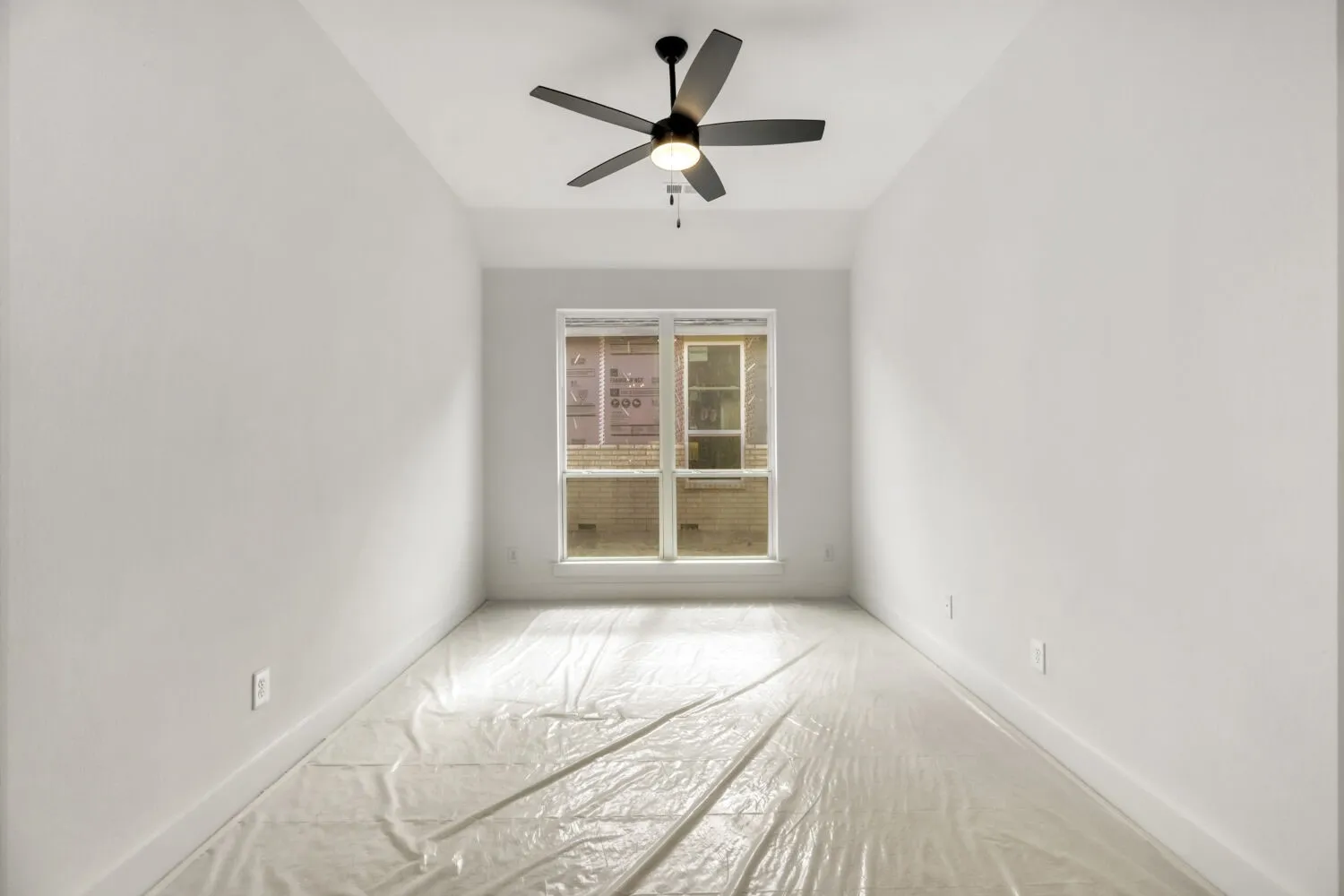 Unfurnished room featuring a ceiling fan and baseboards