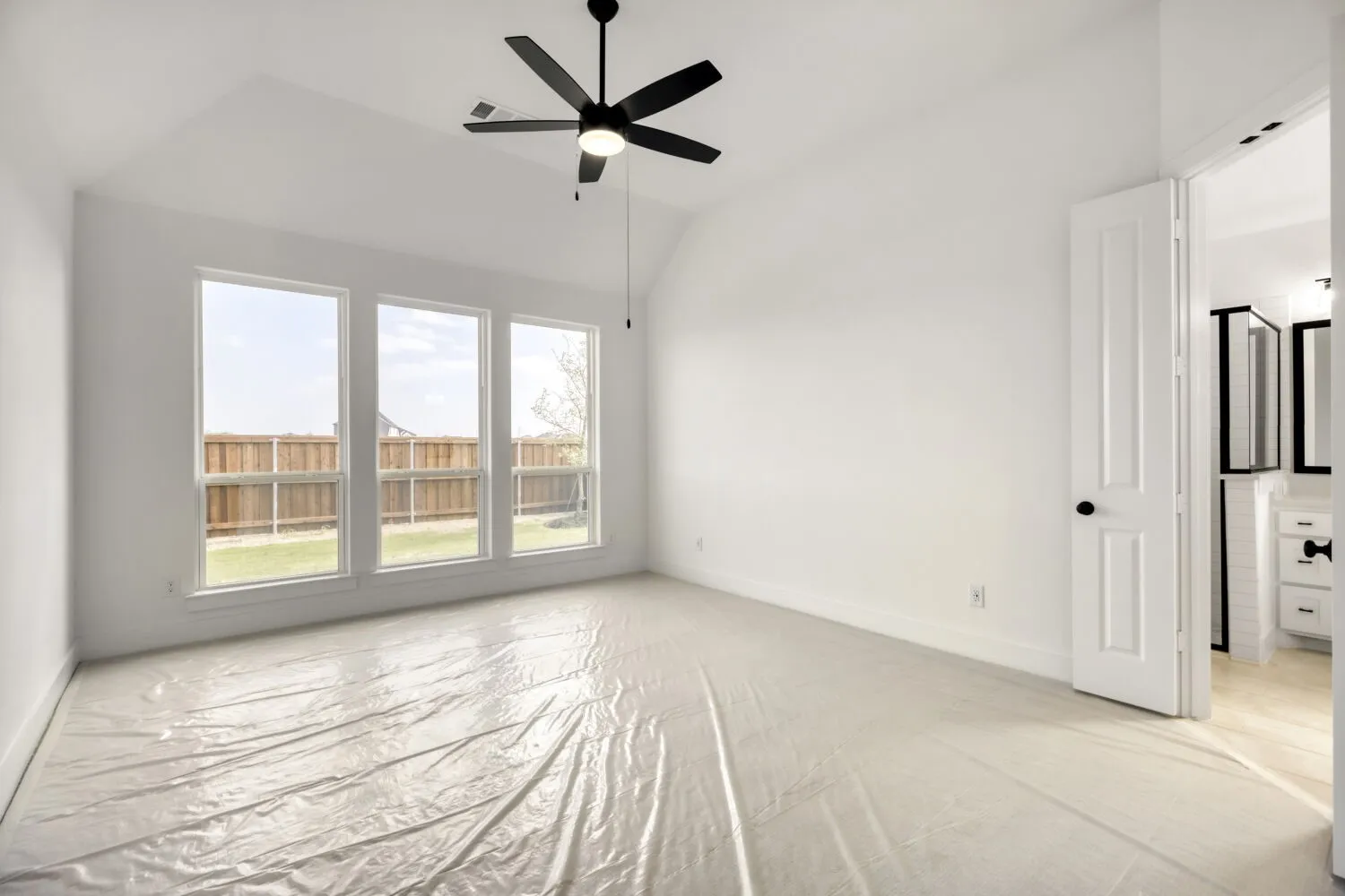 Unfurnished bedroom with lofted ceiling and ceiling fan