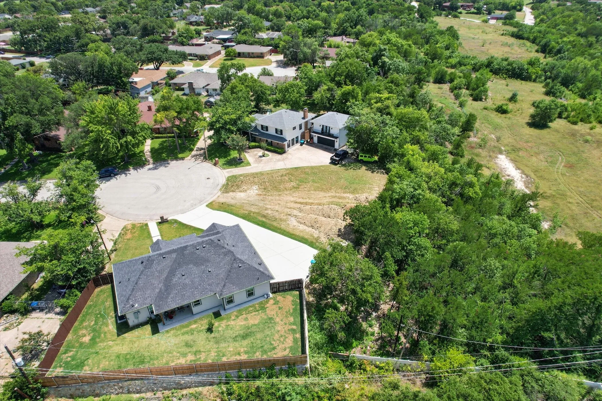 Aerial perspective showcasing a cul-de-sac with surrounding properties