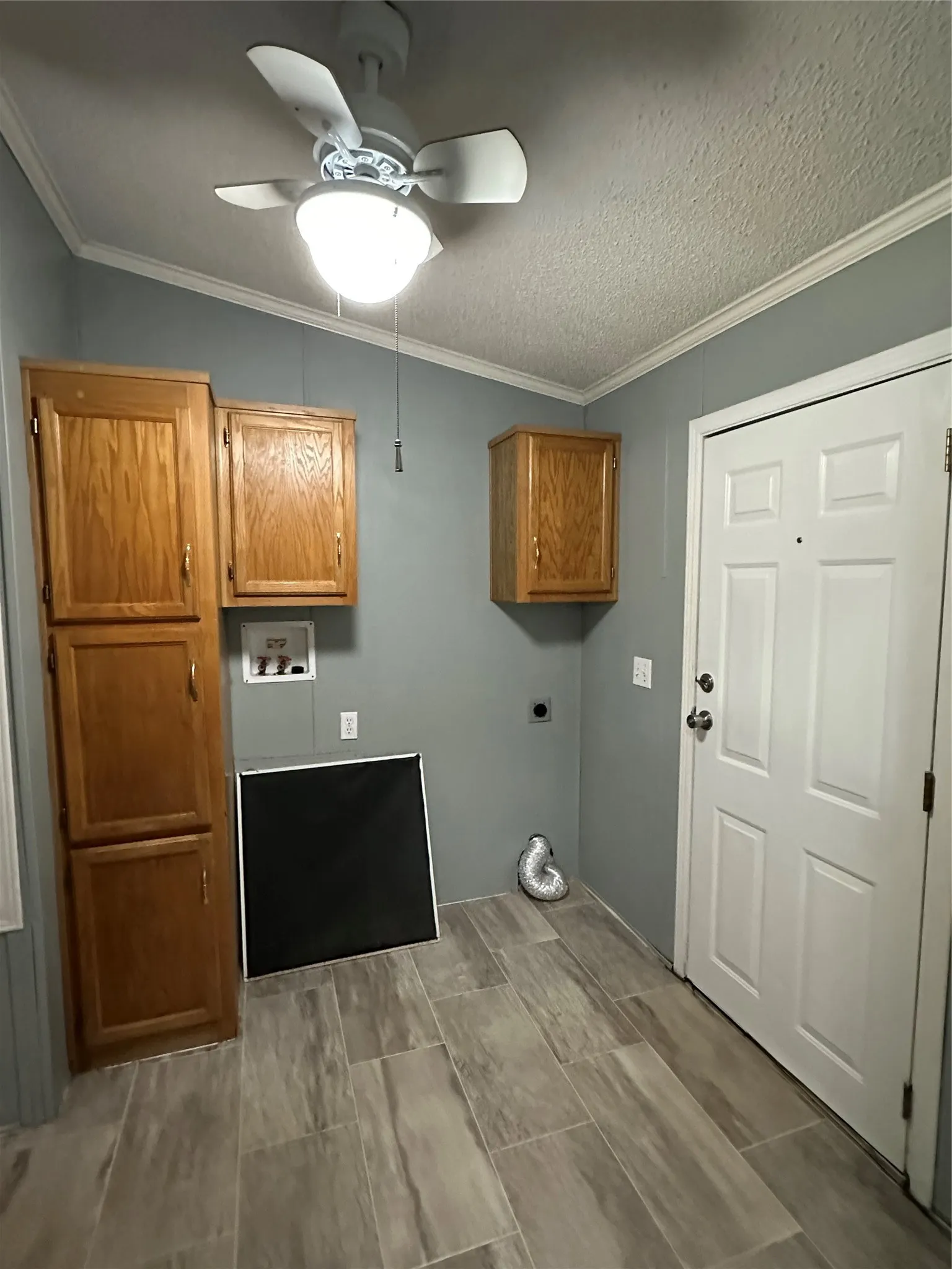 Space for full size W/D with hook-ups in place. Lots of storage cabinets. Exit to back deck.