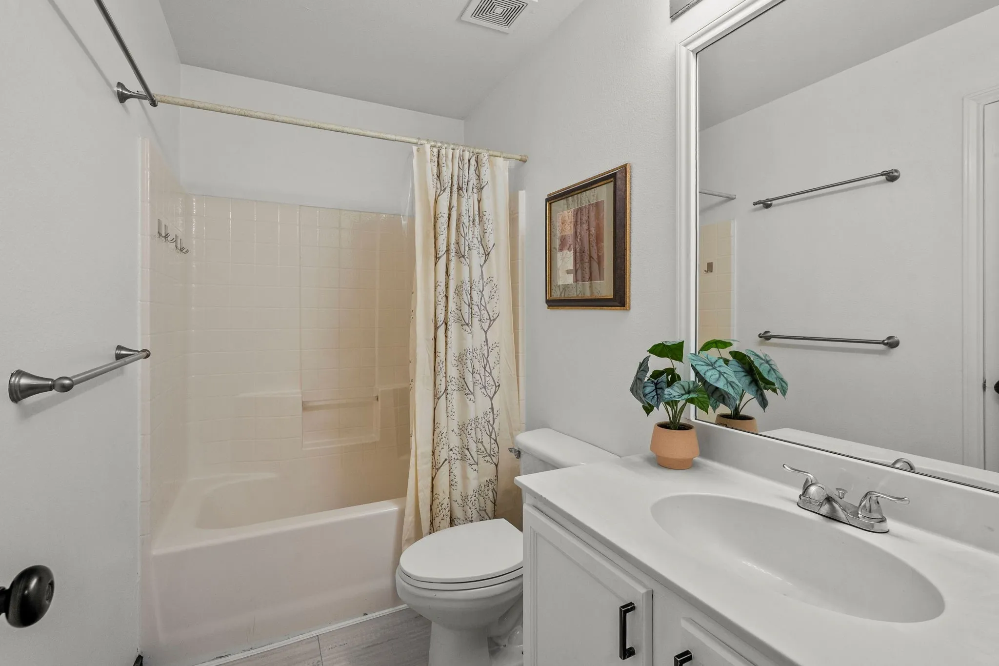 Full bath with shower / bath combo with shower curtain and vanity