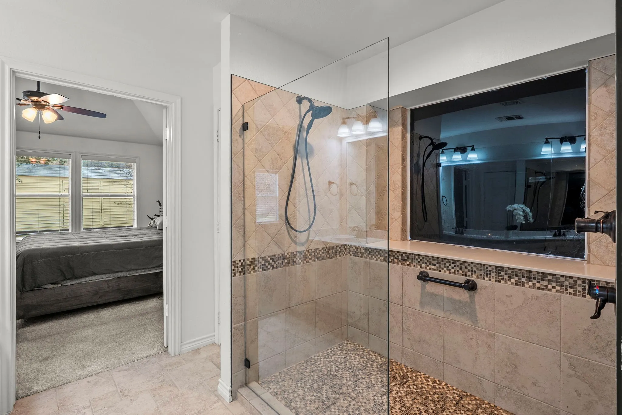 Full bath with ensuite bathroom, a walk in shower, ceiling fan, and light colored carpet