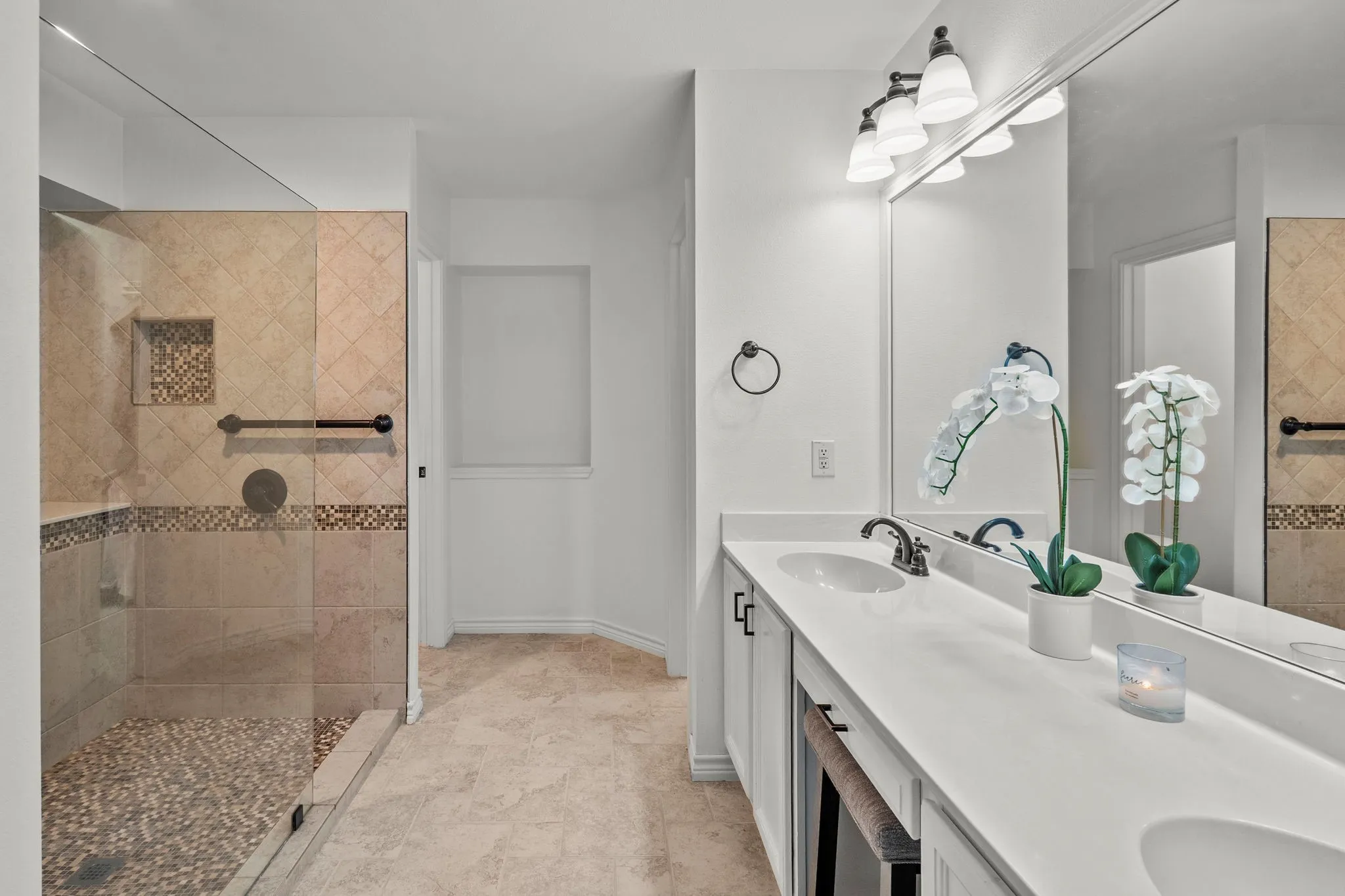 Full bathroom featuring walk in shower and double vanity