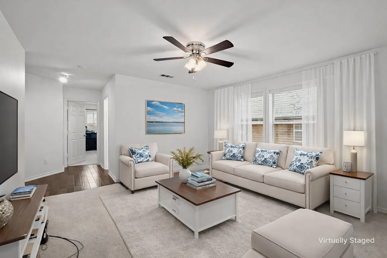 Living room featuring a ceiling fan and wood finished floors
