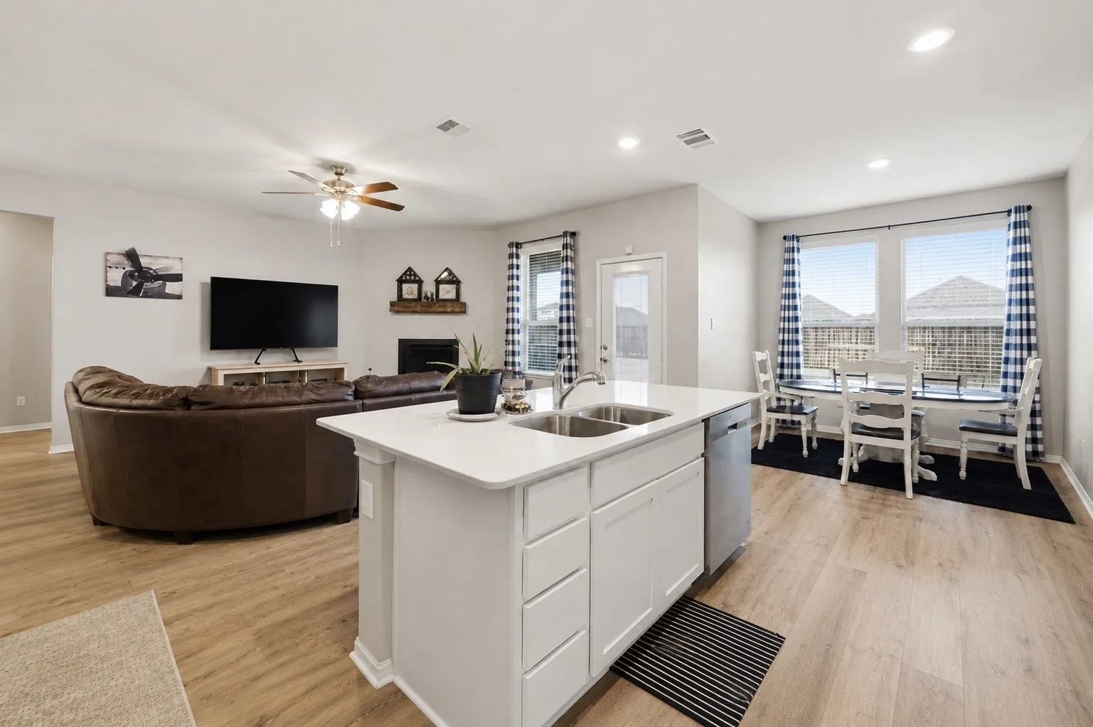 Open-concept living space featuring wood-finish flooring throughout