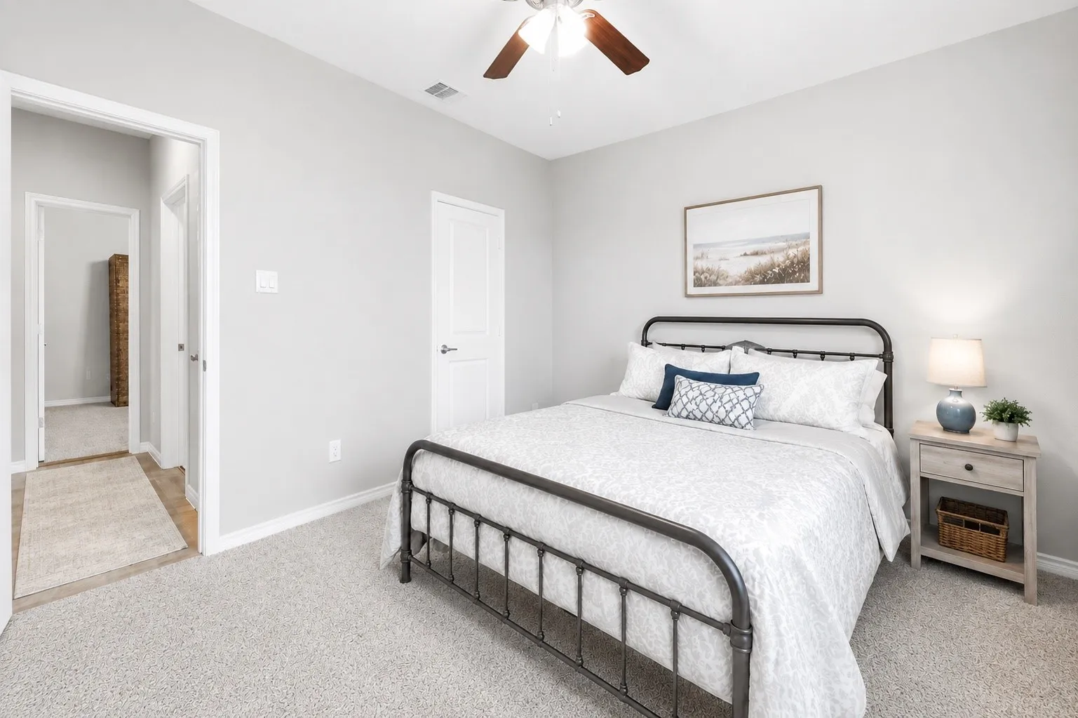 Light gray walls complement the neutral-toned carpet flooring