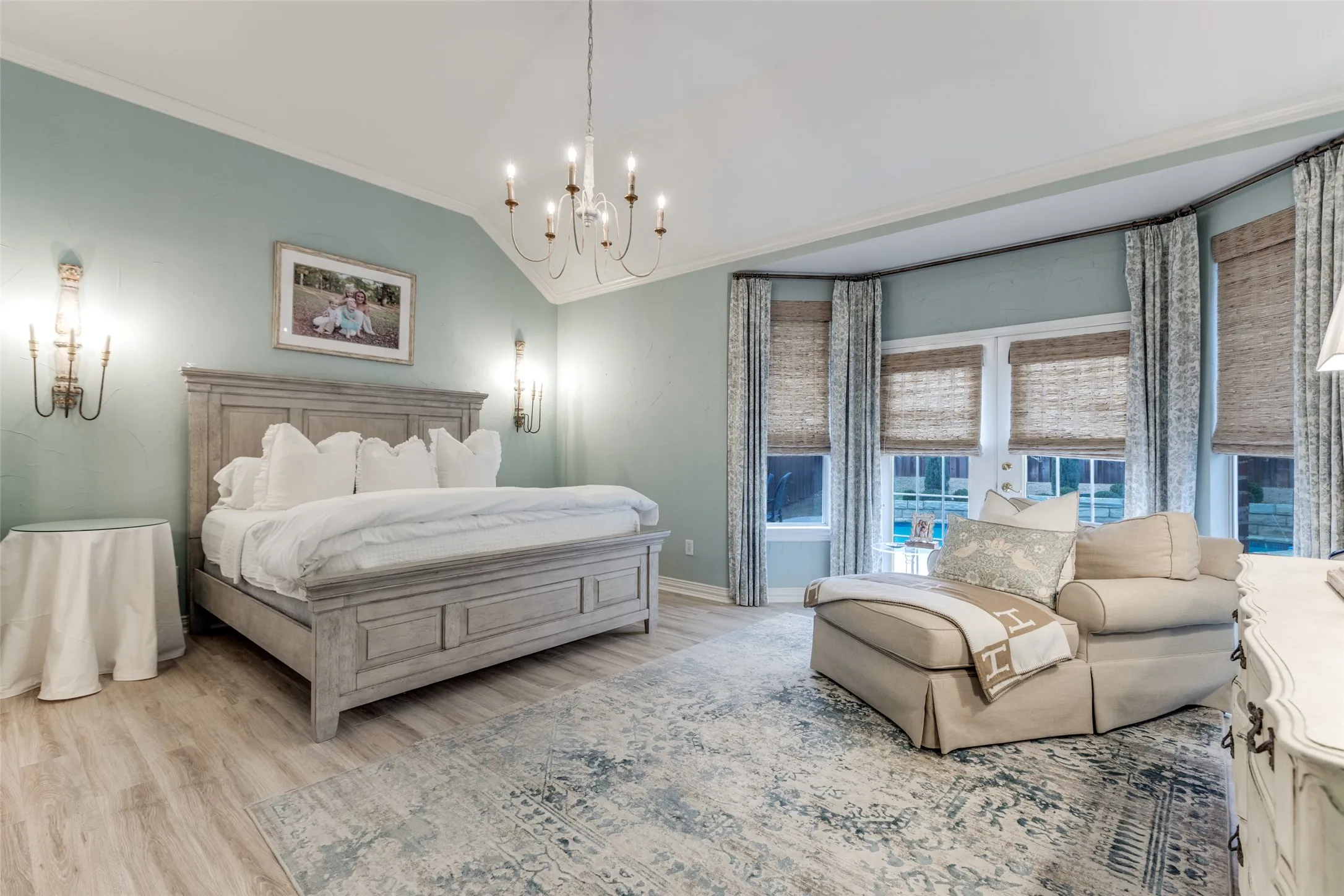 1st Floor Primary bedroom with sitting area opening onto pool and spa area