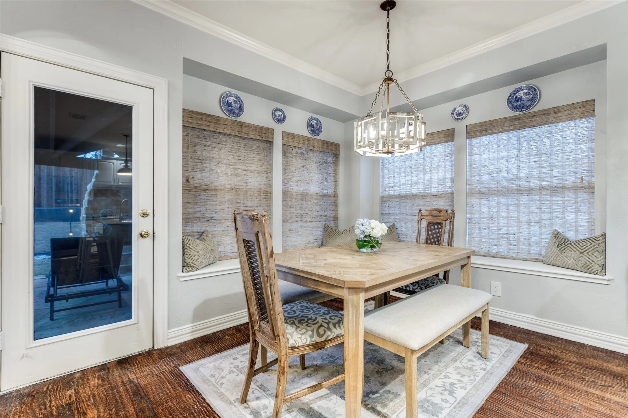 Dining area in kitchen opens to outdoor living with fireplace, pool and spa.
