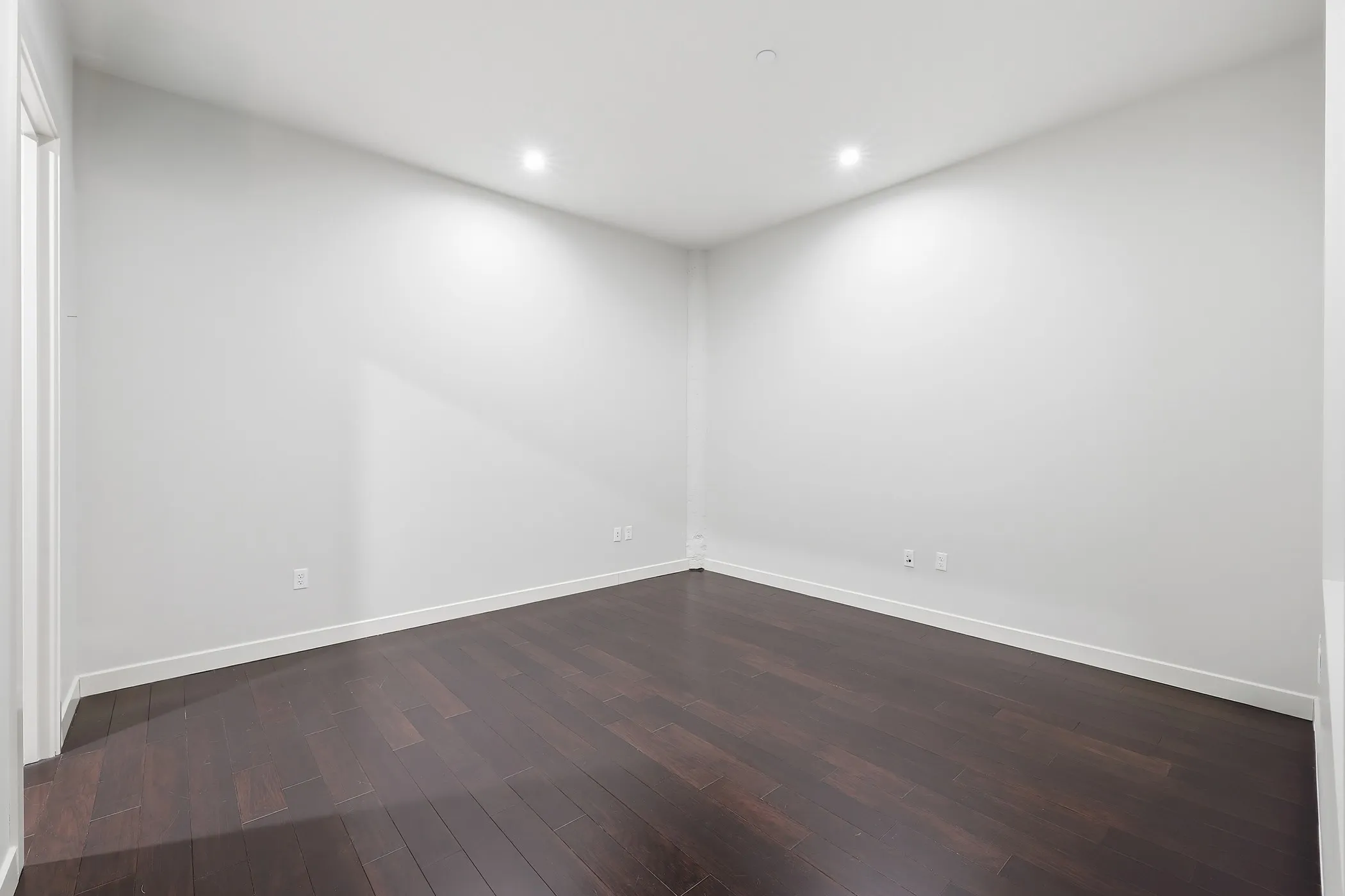 Unfurnished room with dark wood finished floors and recessed lighting